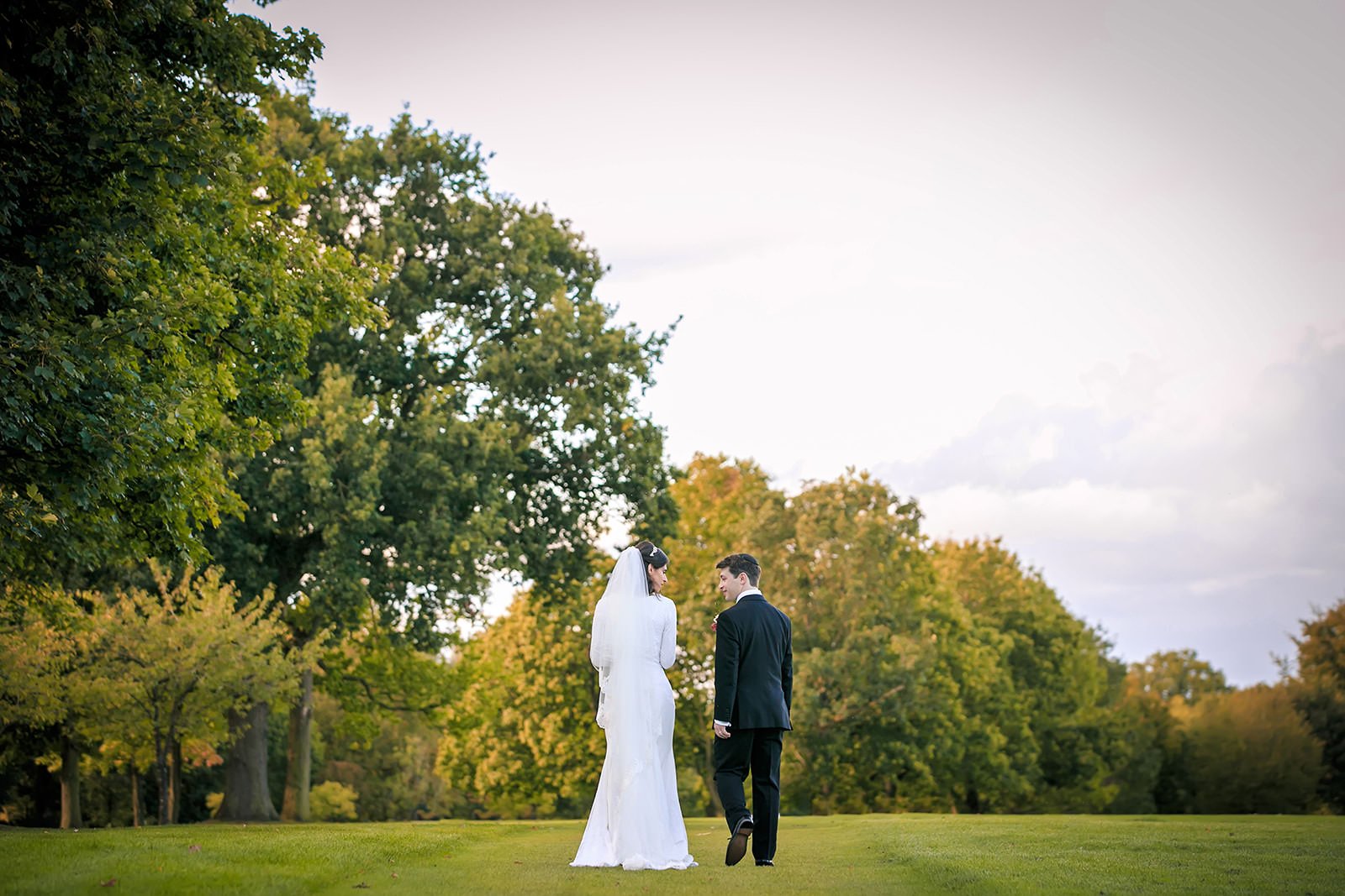 bride groom newlywed couple portrait walking away during wedding at mere golf resort in cheshire