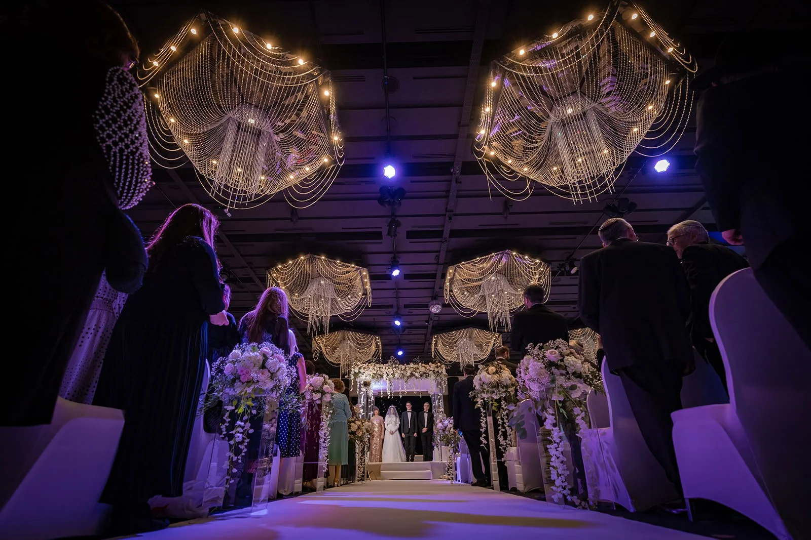 wide angle of bride and groom exchange vows during wedding ceremony in international suite at mercure manchester piccadilly
