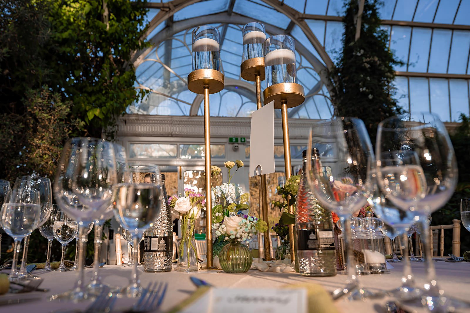 sefton park palm house wedding venue interior set up with tables and decor for reception dinner and dancing