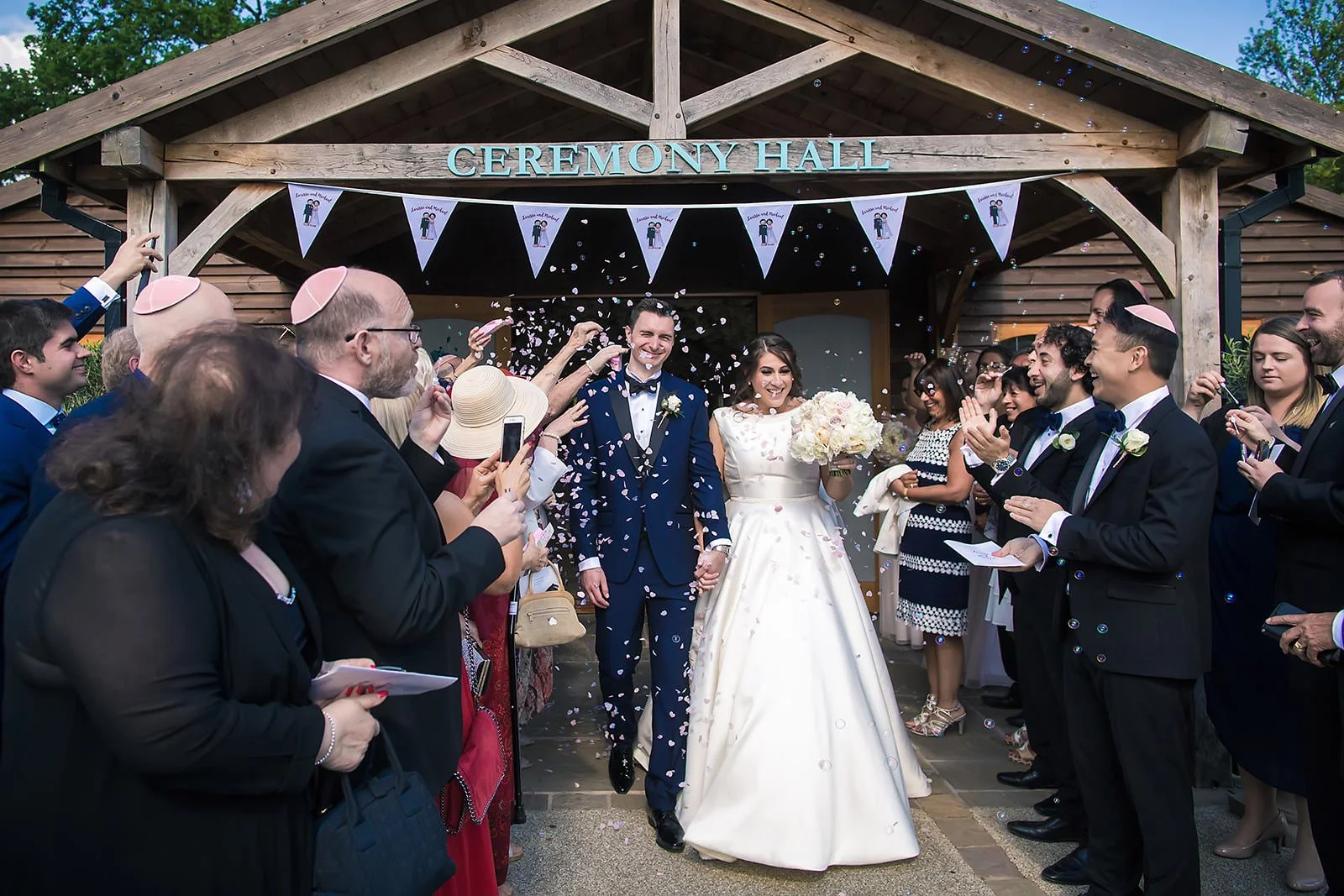 bride and groom get covered in confetti at colshaw hall wedding venue in cheshire