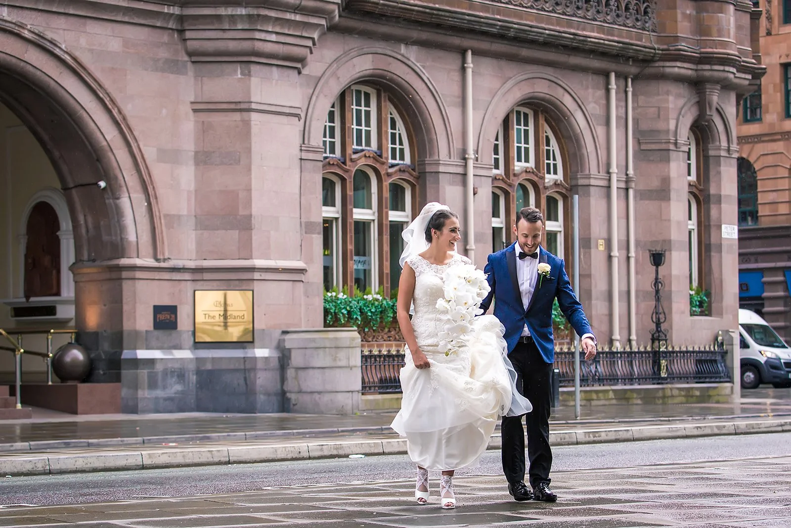 newlywed bride and groom walking outside Midland hotel in Manchester city center