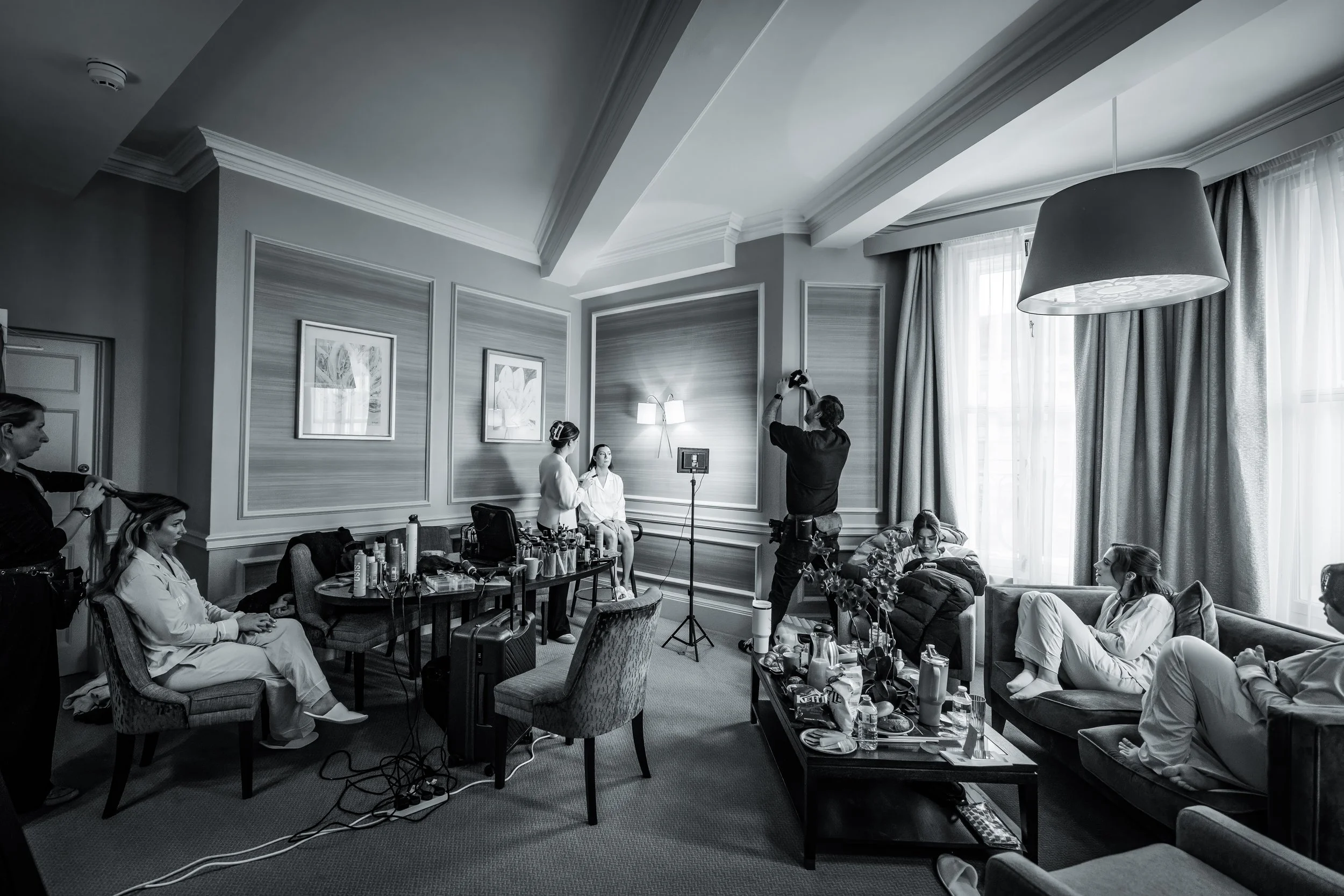 wide angle scene of bride and bridesmaidsgetting ready during bridal prep at midland hotel manchester