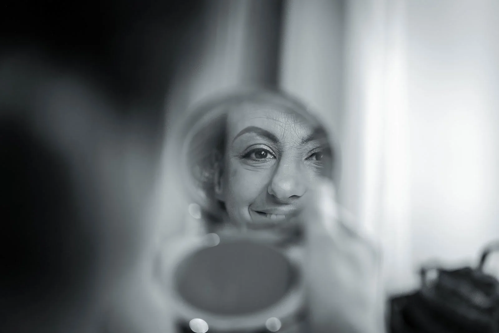 bride looking in mirror during bridal prep at worsley marriott hotel