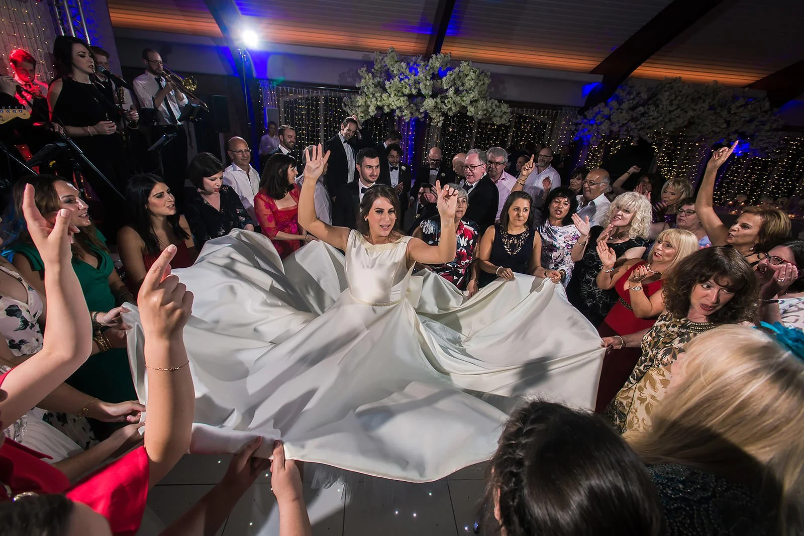 bride has dress fanned out on dance floor at colshaw hall wedding venue