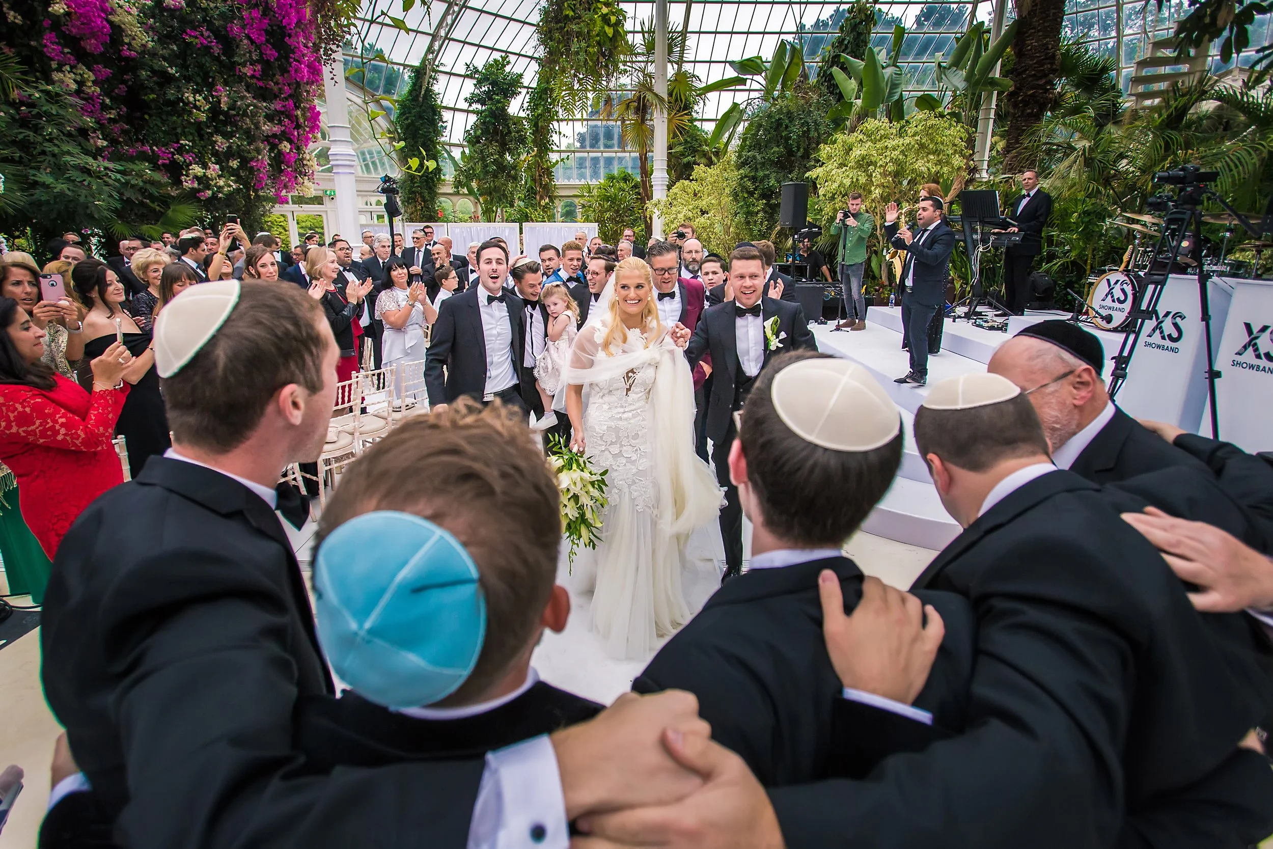 bride and groom leave ceremony at sefton park palm house wedding venue in liverpool