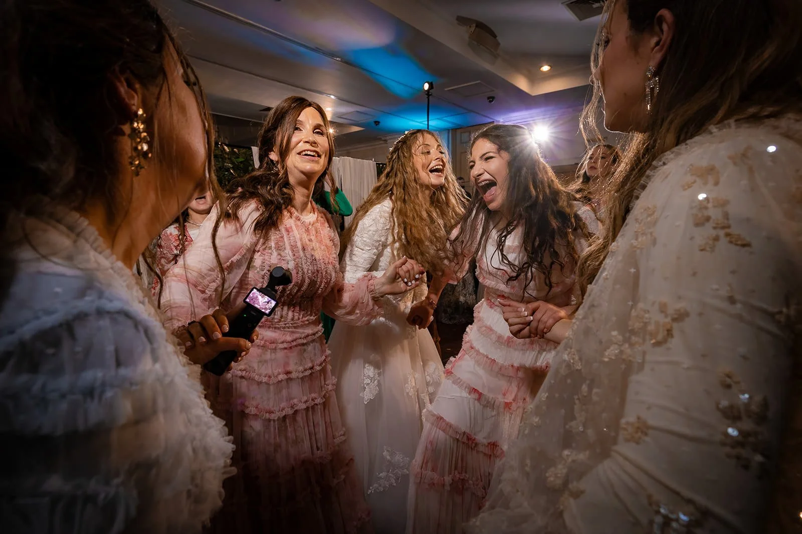 bride and friends dancing during wedding party reception at last drop village in bolton