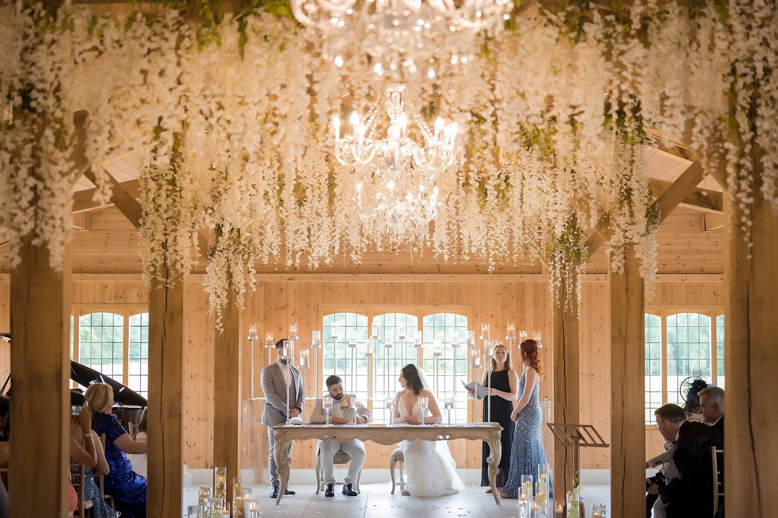 bride and groom sign register during wedding ceremony at merrydale manor in cheshire