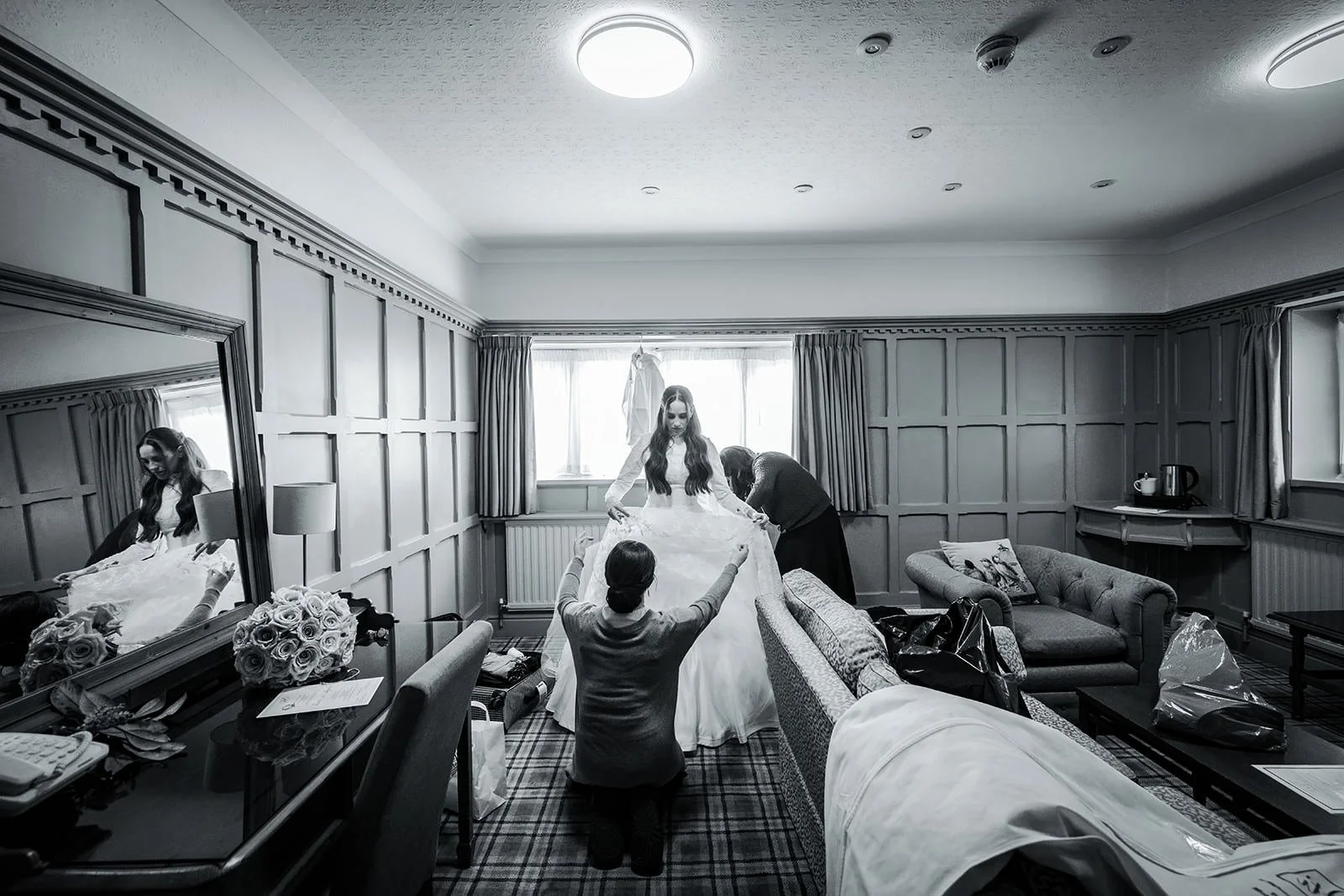 bride getting in dress during bridal prep at last drop village in bolton