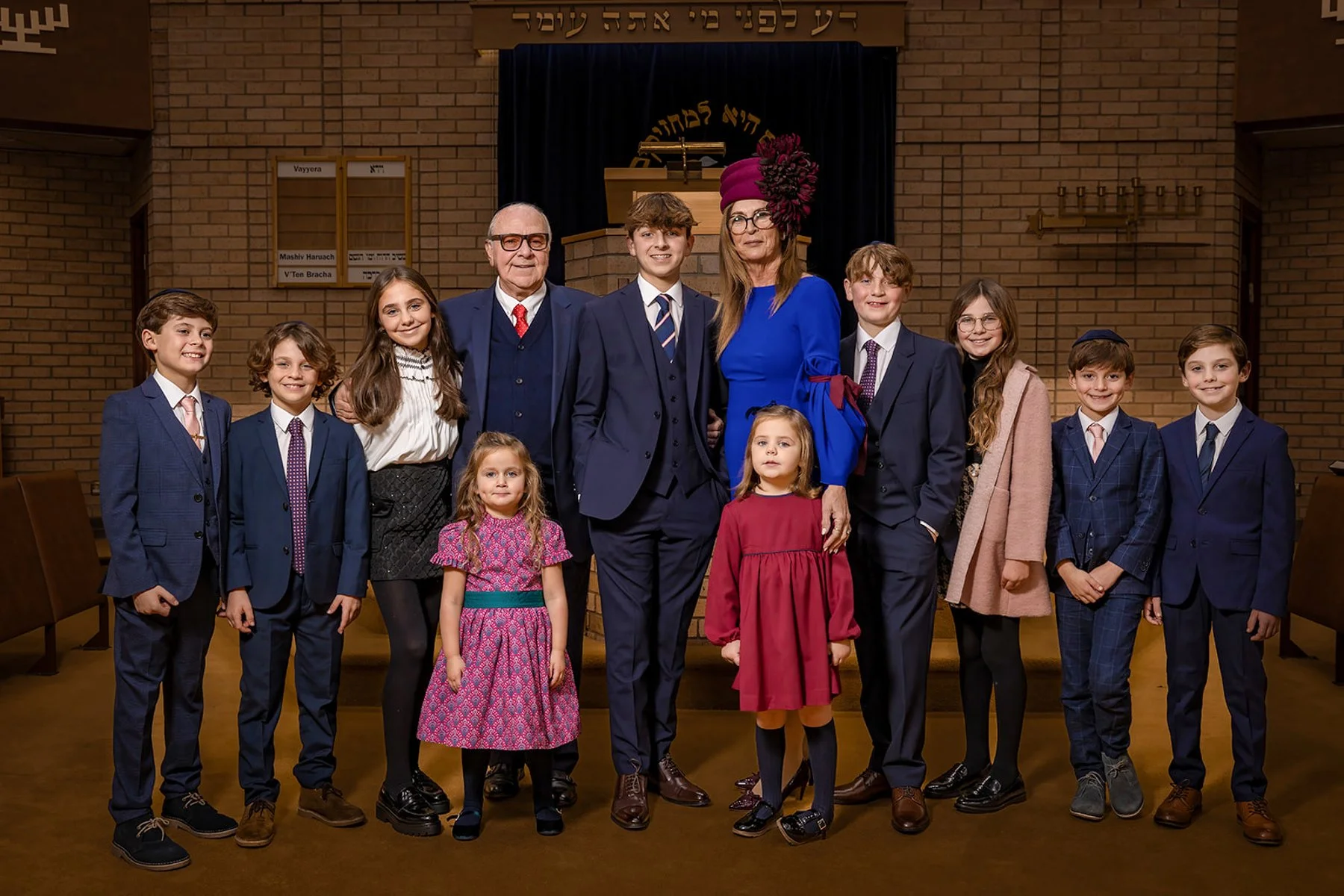 Posed family portrait in synagogue during barmitzvah rehearsal