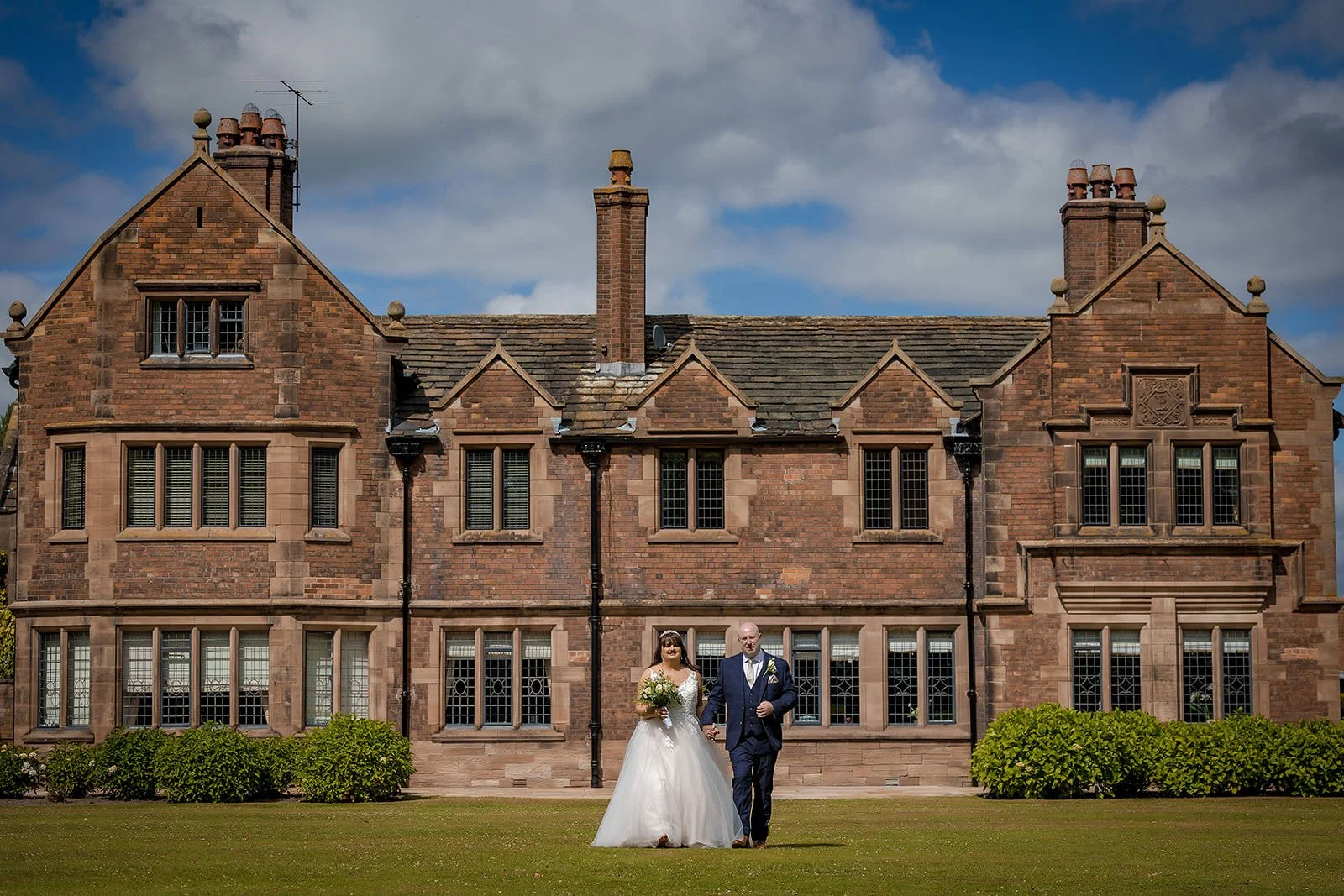 Bride and groom portrait with exterior of colshaw hall in background