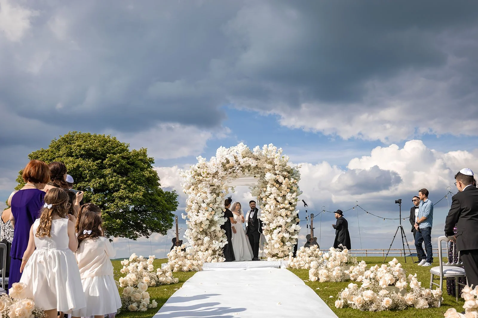 bride and groom exchange vows during outdoor wedding ceremony at heaton house farm in macclesfield