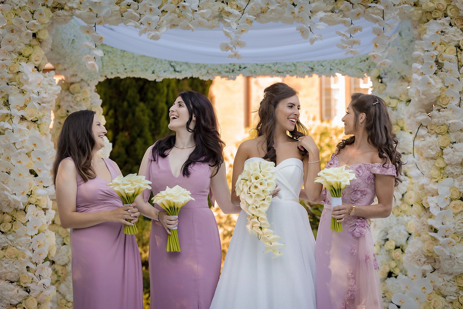 bridesmaid and bride portrait outdoors in italian gardens at nunsmere hall wedding venue in cheshire