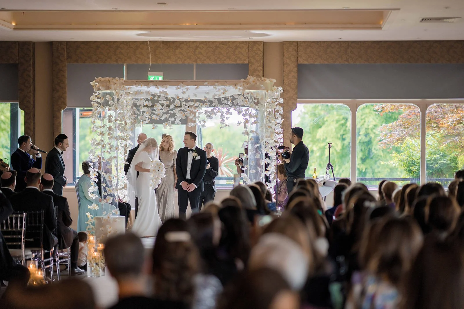 bride and groom exchange vows during wedding ceremony at mere golf resort in cheshire