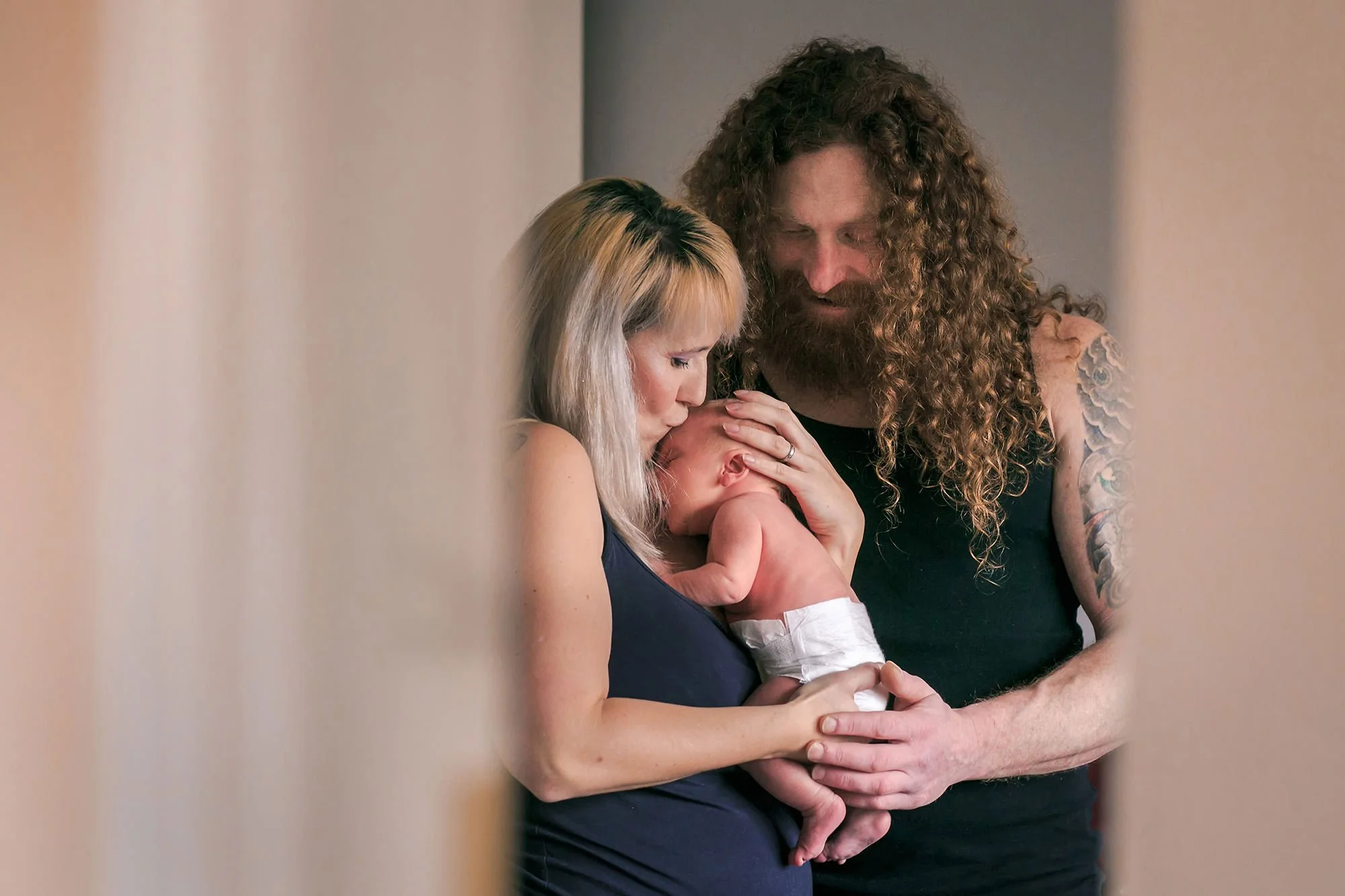newborn baby portrait with mum and dad cuddles