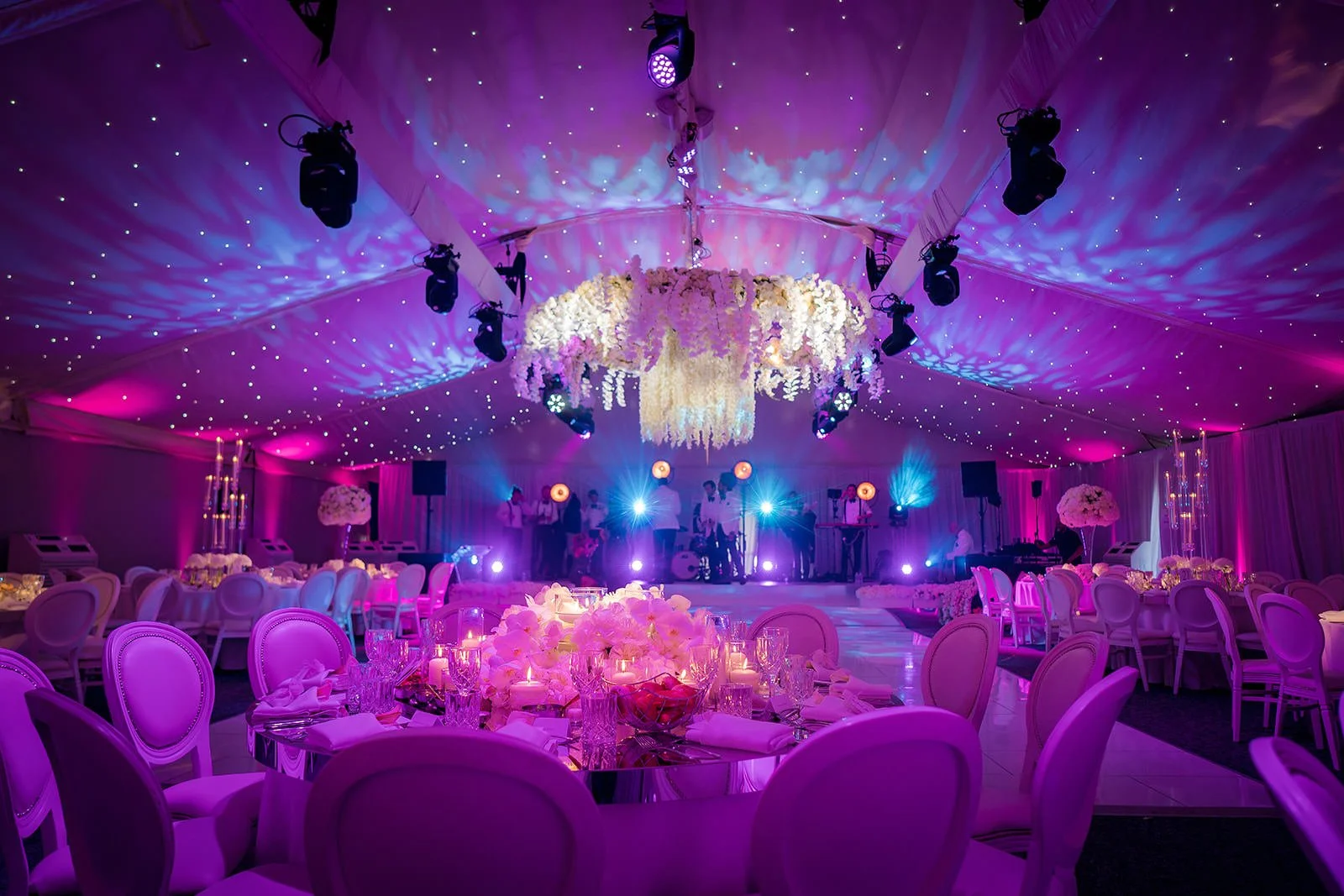 Dramatic Nunsmere Hall marquee interior with purple lighting and chandelier

