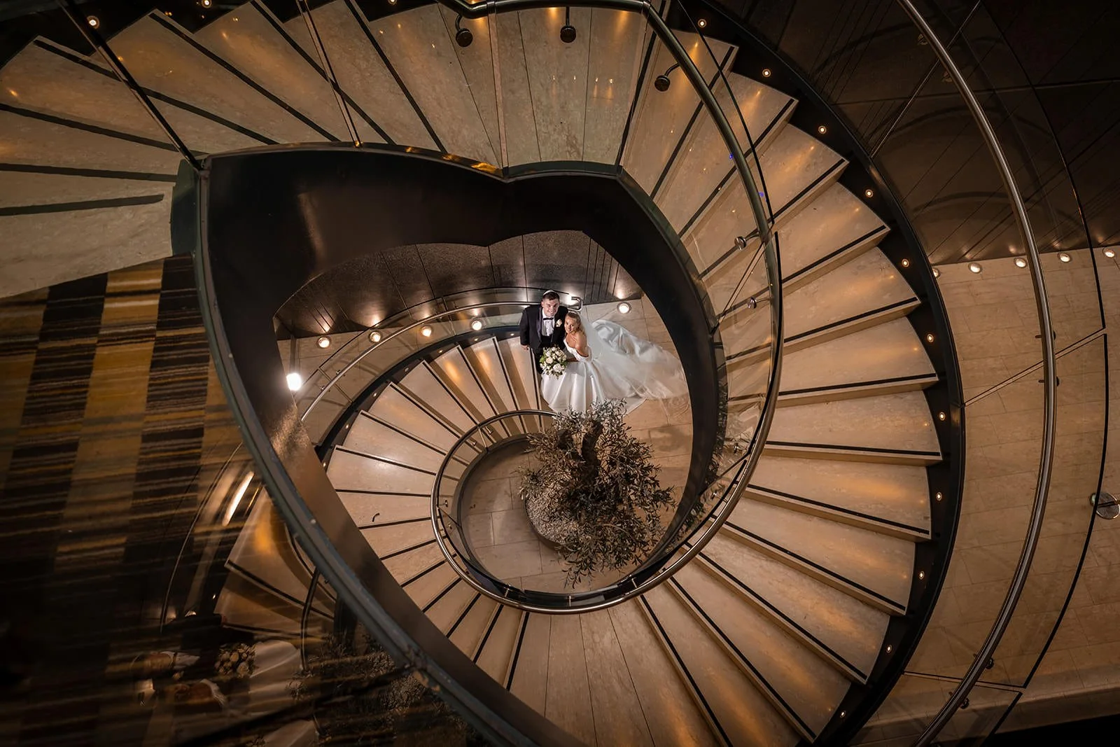 romantic newlywed bride and groom couple portrait on spiral staircase at manchester deansgate hotel