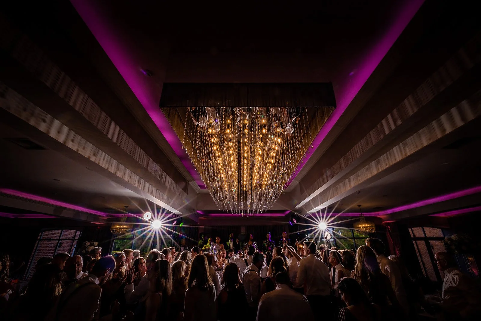 Merrydale Manor wedding reception dance floor under dramatic chandelier with purple lighting – wedding photography Cheshire