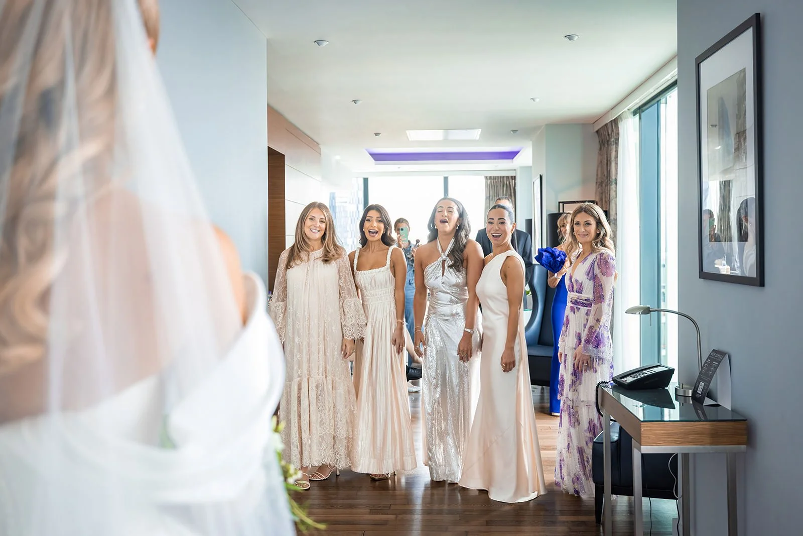 bride first look with bridesmaids during bridal prep at manchester deansgate hotel wedding venue
