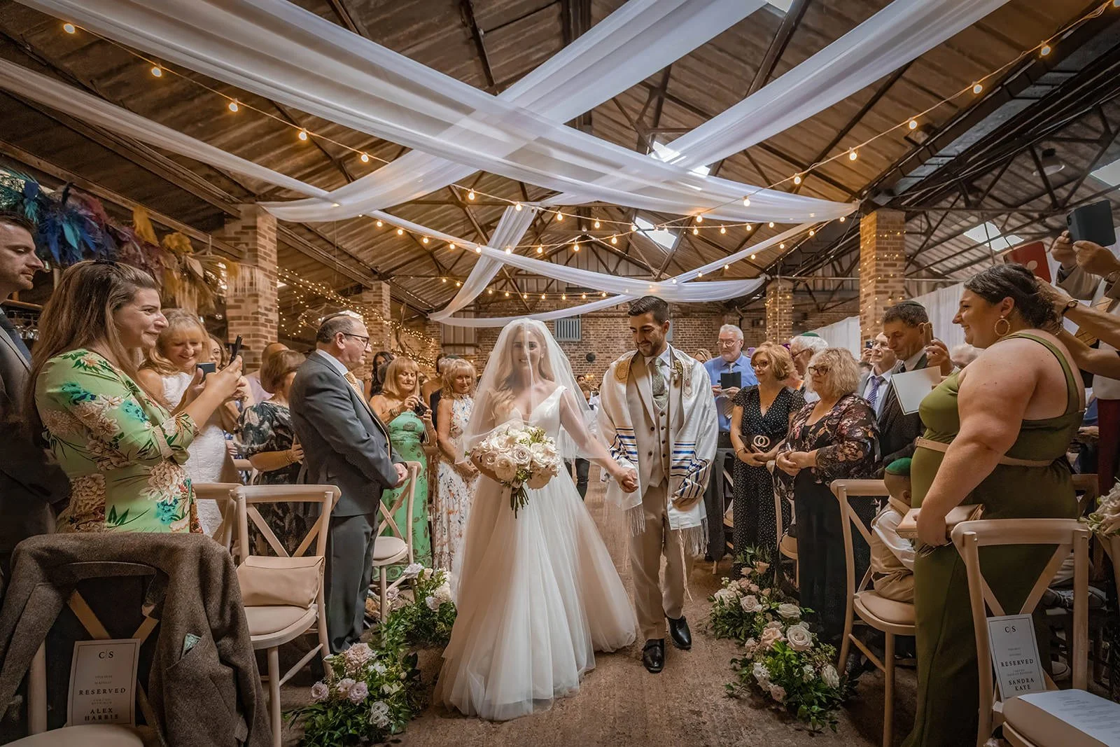 bride and groom walk down aisle during wedding ceremony at white syke fields in yorkshire