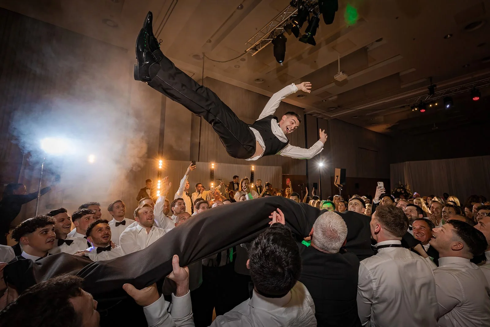 groom thrown in air at wedding reception dance floor at manchester deansgate hotel