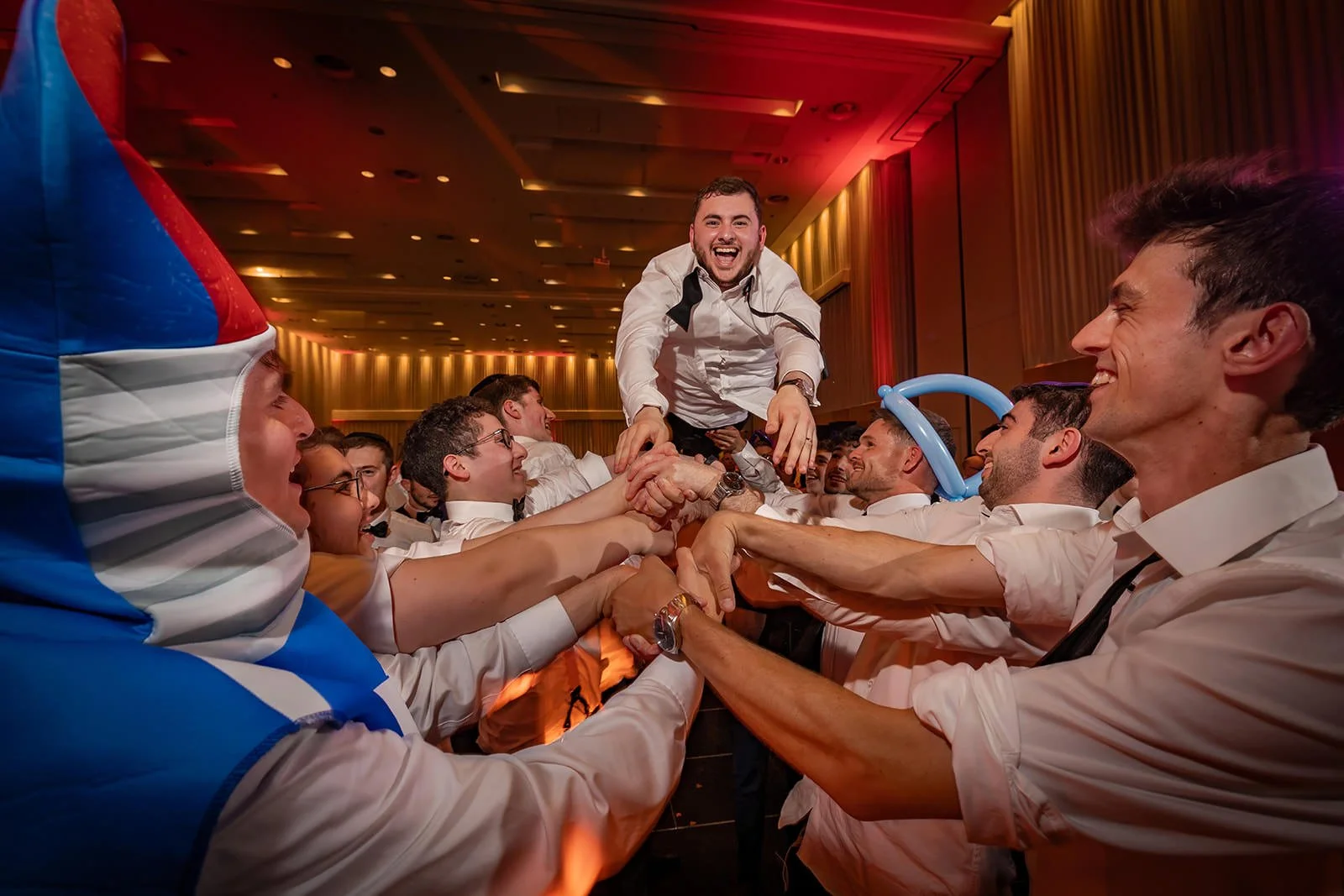 groom thrown in air at wedding reception dance floor at manchester deansgate hotel