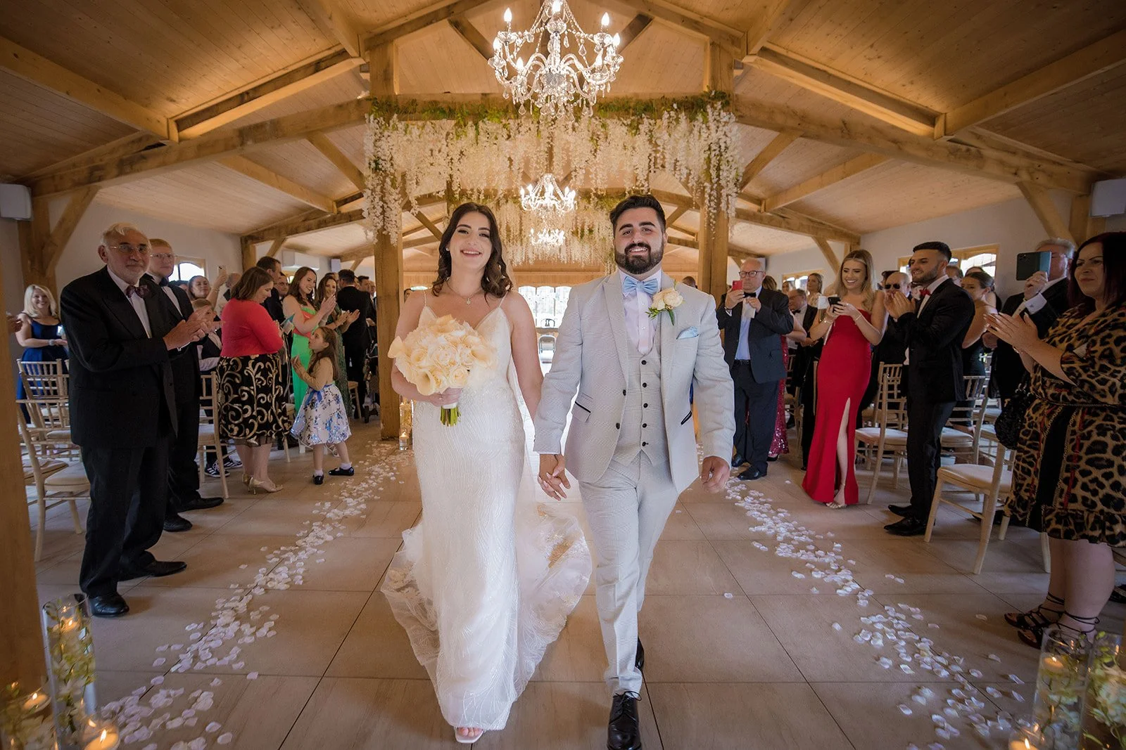 bride and groom leave wedding ceremony at merrydale manor in cheshire
