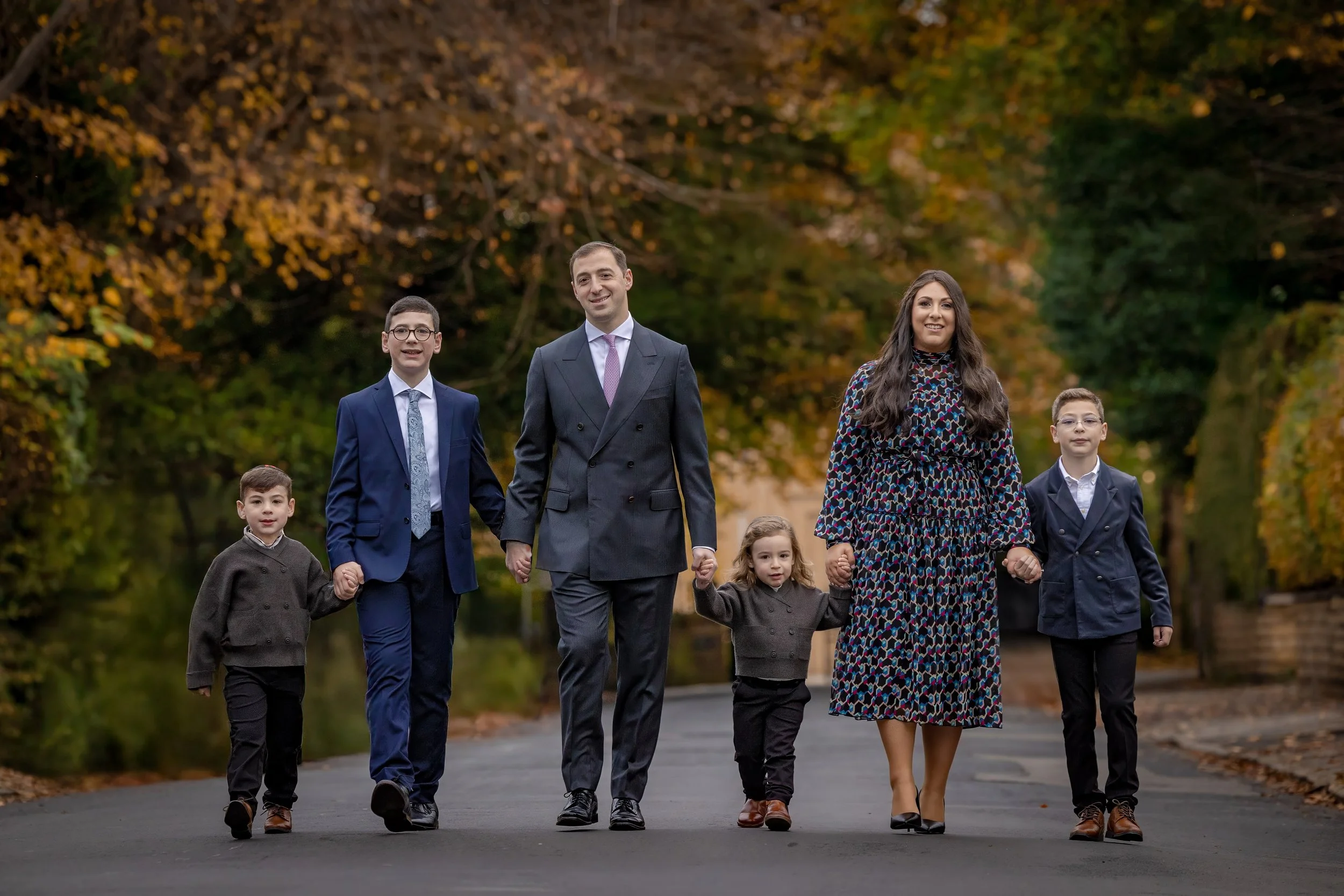 barmitzvah boy and family walking portrait in park in Manchester