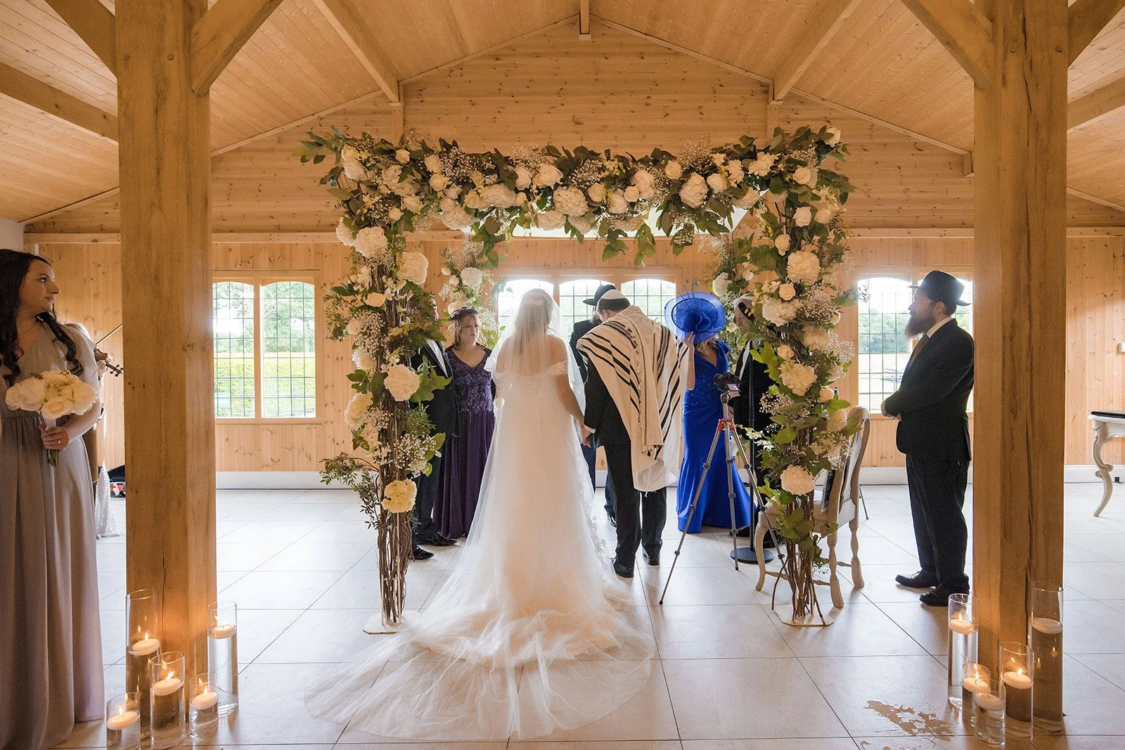 Merrydale Manor wedding ceremony couple under floral arch wooden venue – wedding photography North West