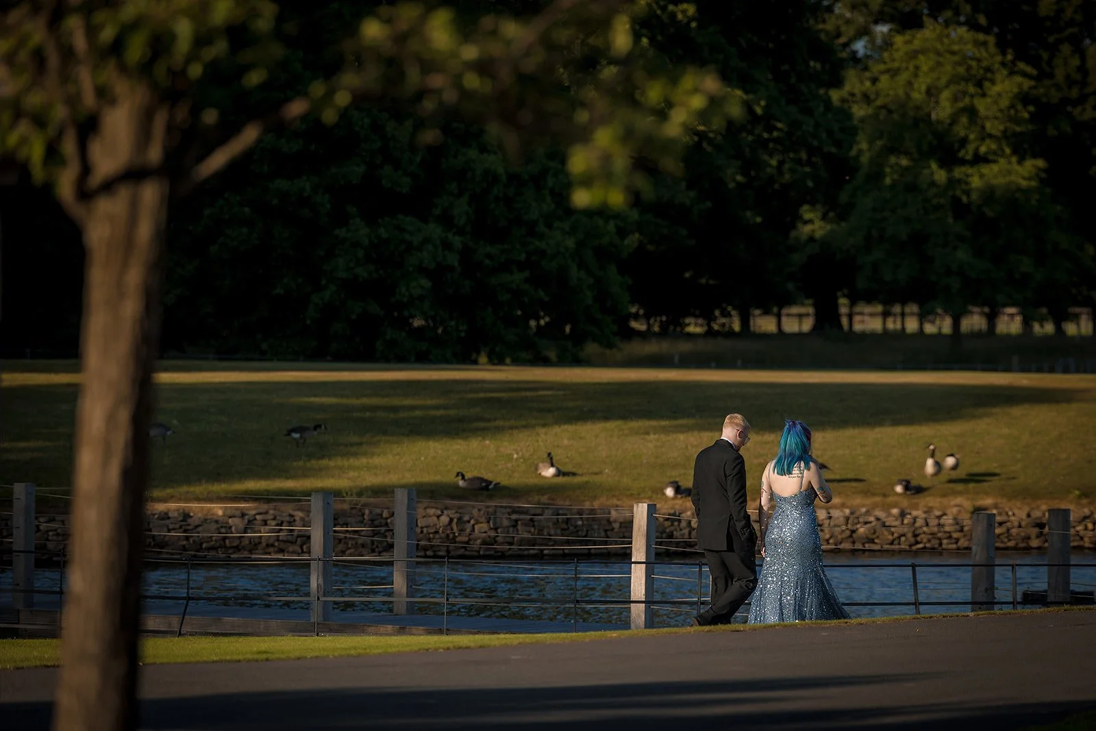 Merrydale Manor wedding couple walking along riverbank at sunset – Manchester wedding photographer