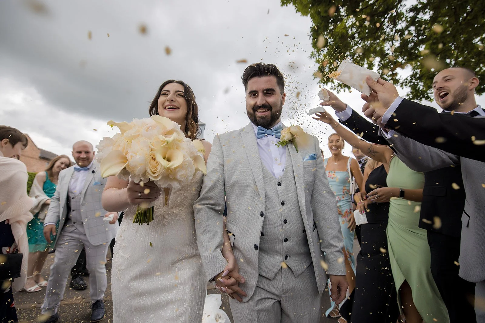 Merrydale Manor wedding couple holding hands confetti outdoors – documentary wedding photographer Manchester