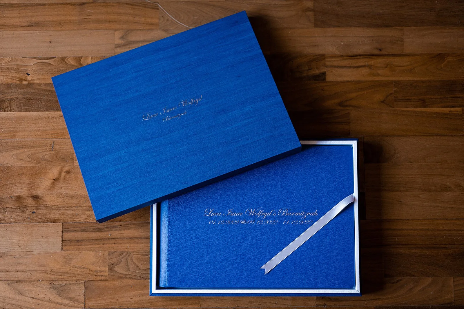 blue leather wedding album in maple presentation box with names on cover