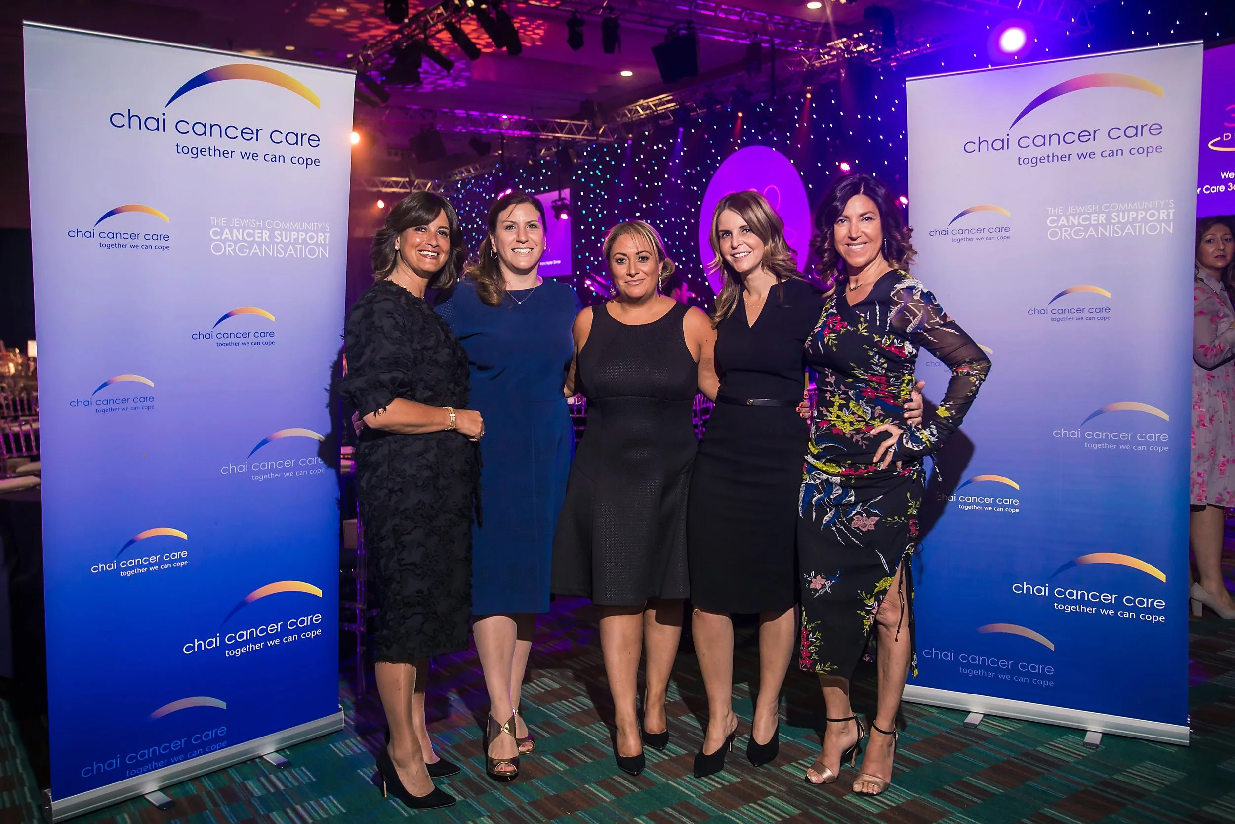 Guests posing for a photograph at a charity fundraising gala