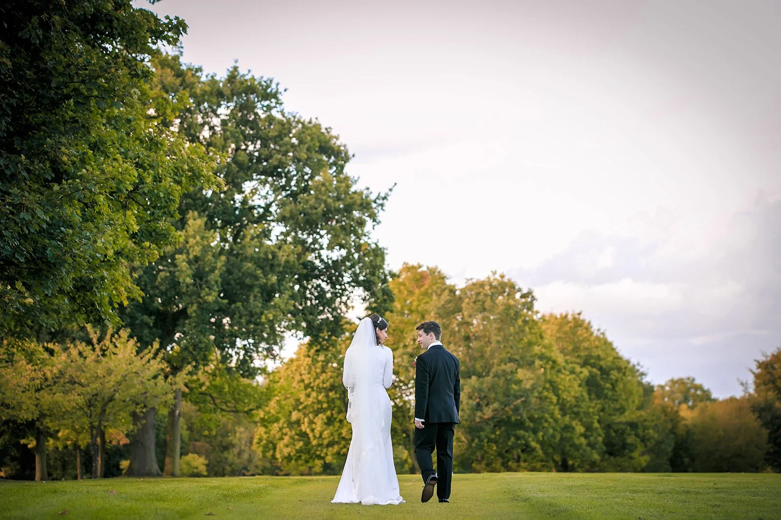 Couple portrait on open grounds with mature trees, Fairmont Cheshire - The Mere
