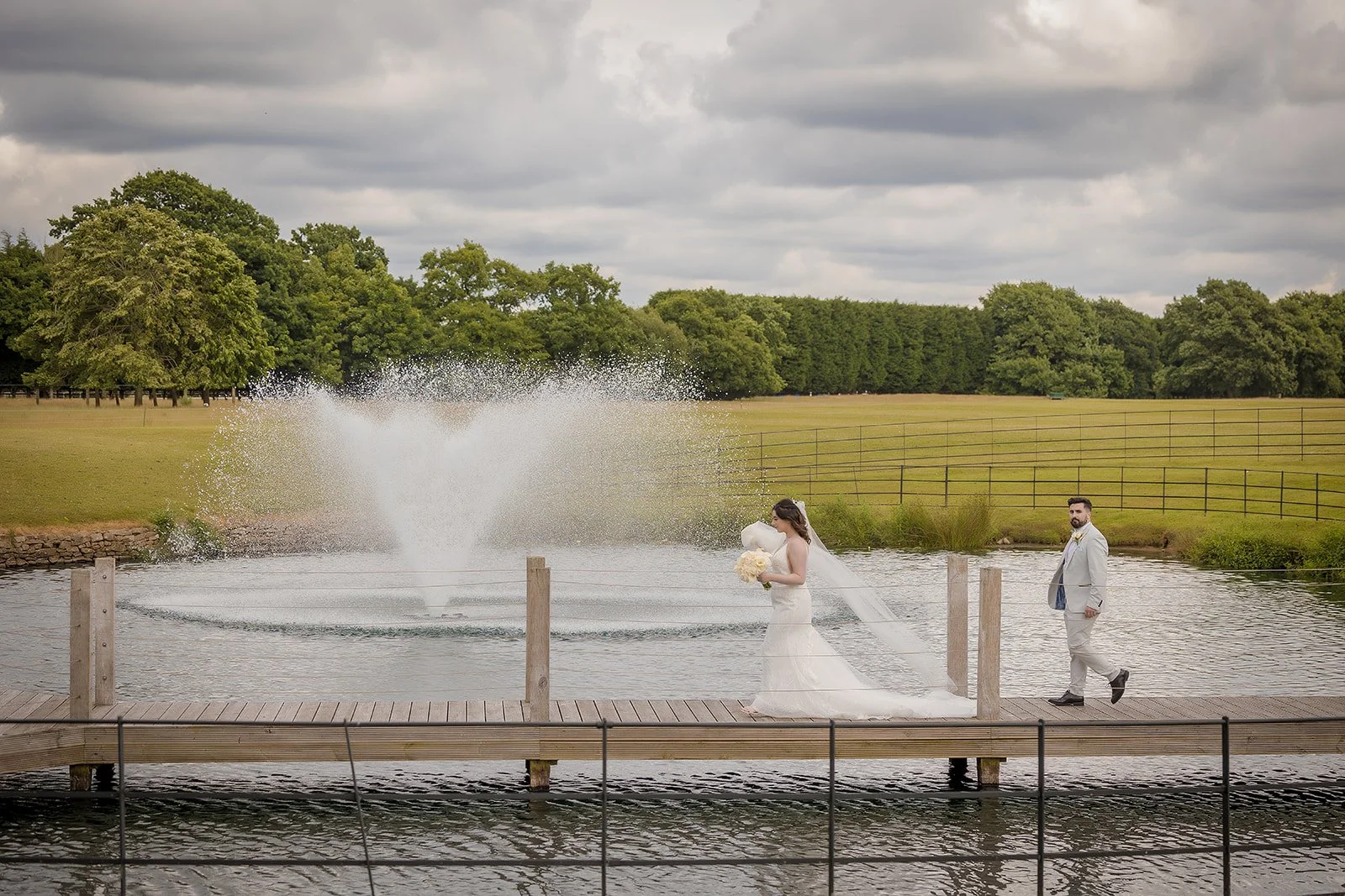 bride and groom romantic portrait on the jetty over the pond at merrydale manor wedding venue