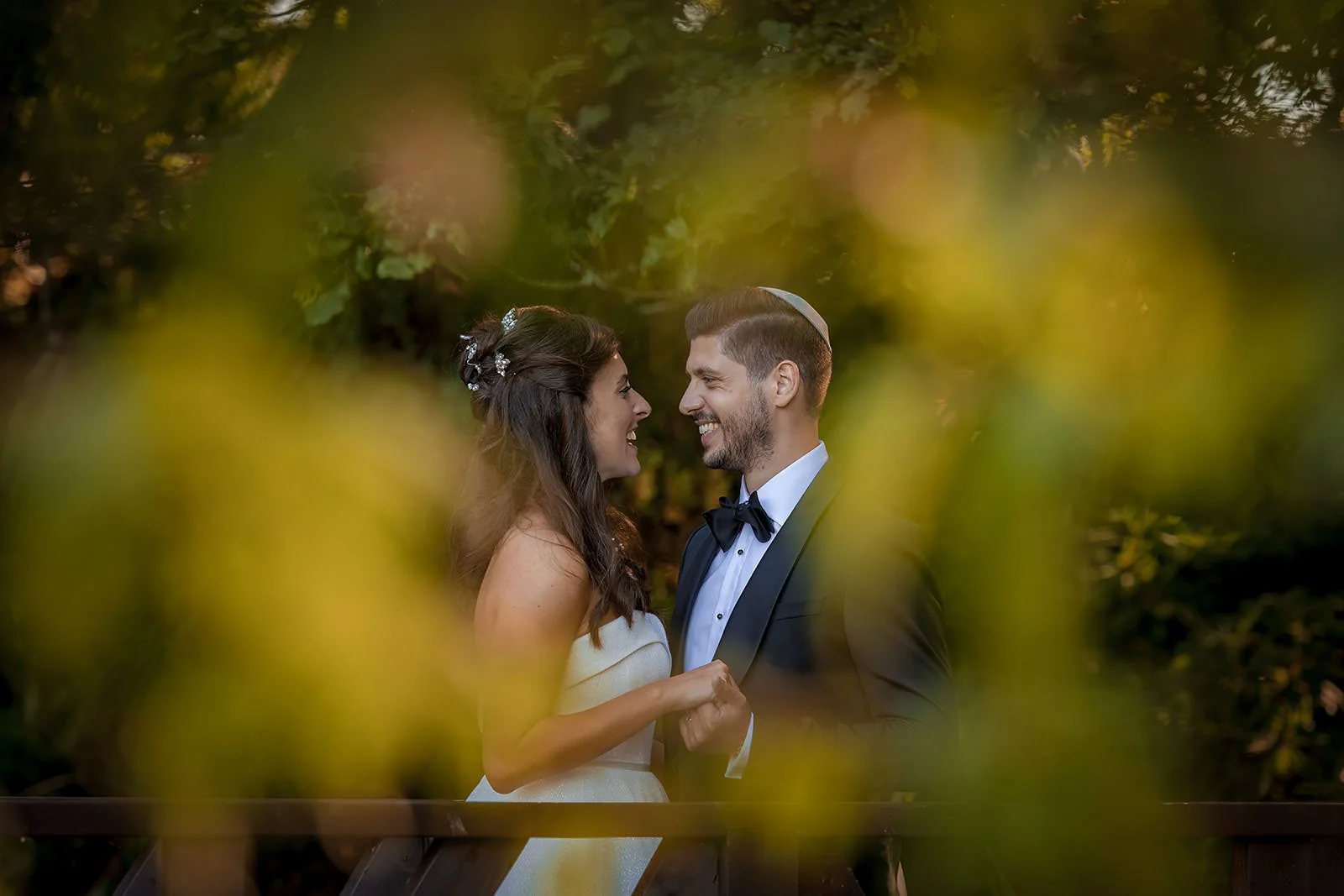 Intimate couple portrait framed through golden autumn foliage, Nunsmere Hall
