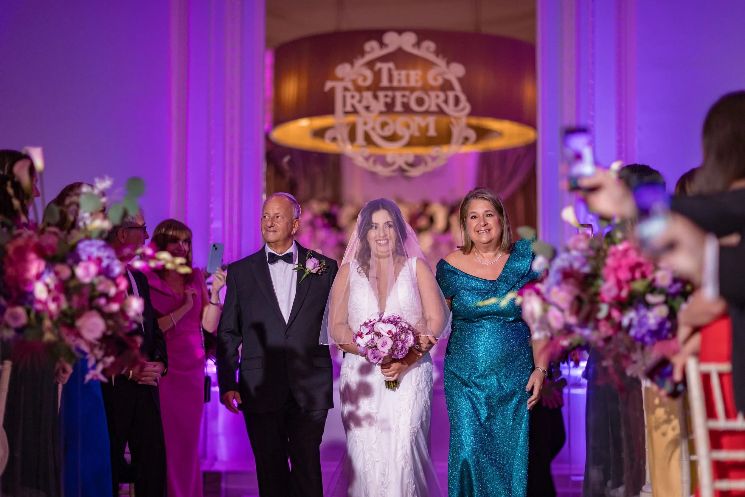 bride and parents walk down aisle at midland hotel in manchester