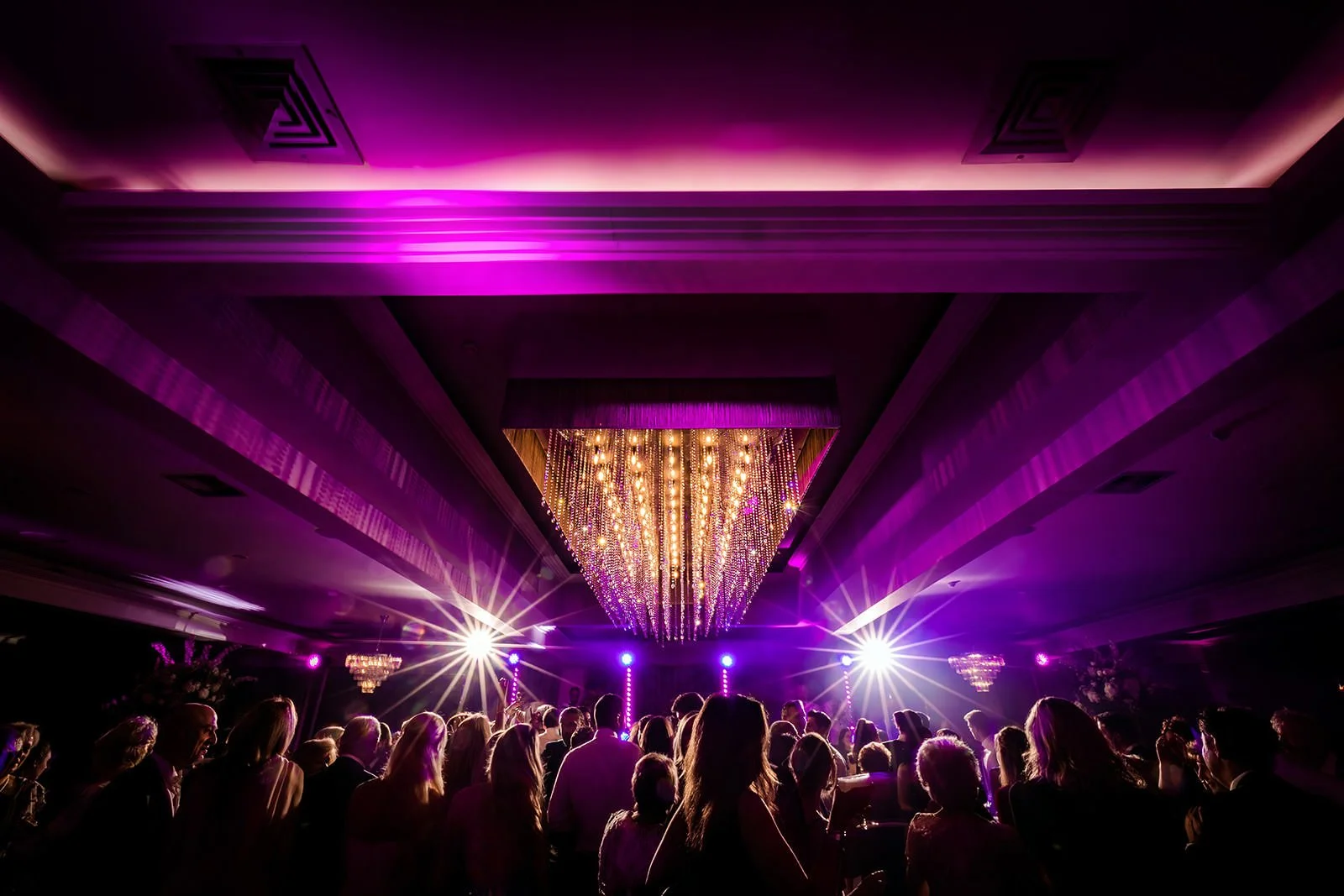 Merrydale Manor wedding reception under chandelier purple lighting – wedding photography North West