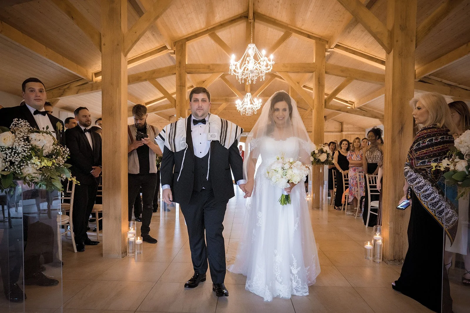Merrydale Manor wedding couple walking hand in hand down aisle – documentary wedding photographer Manchester
