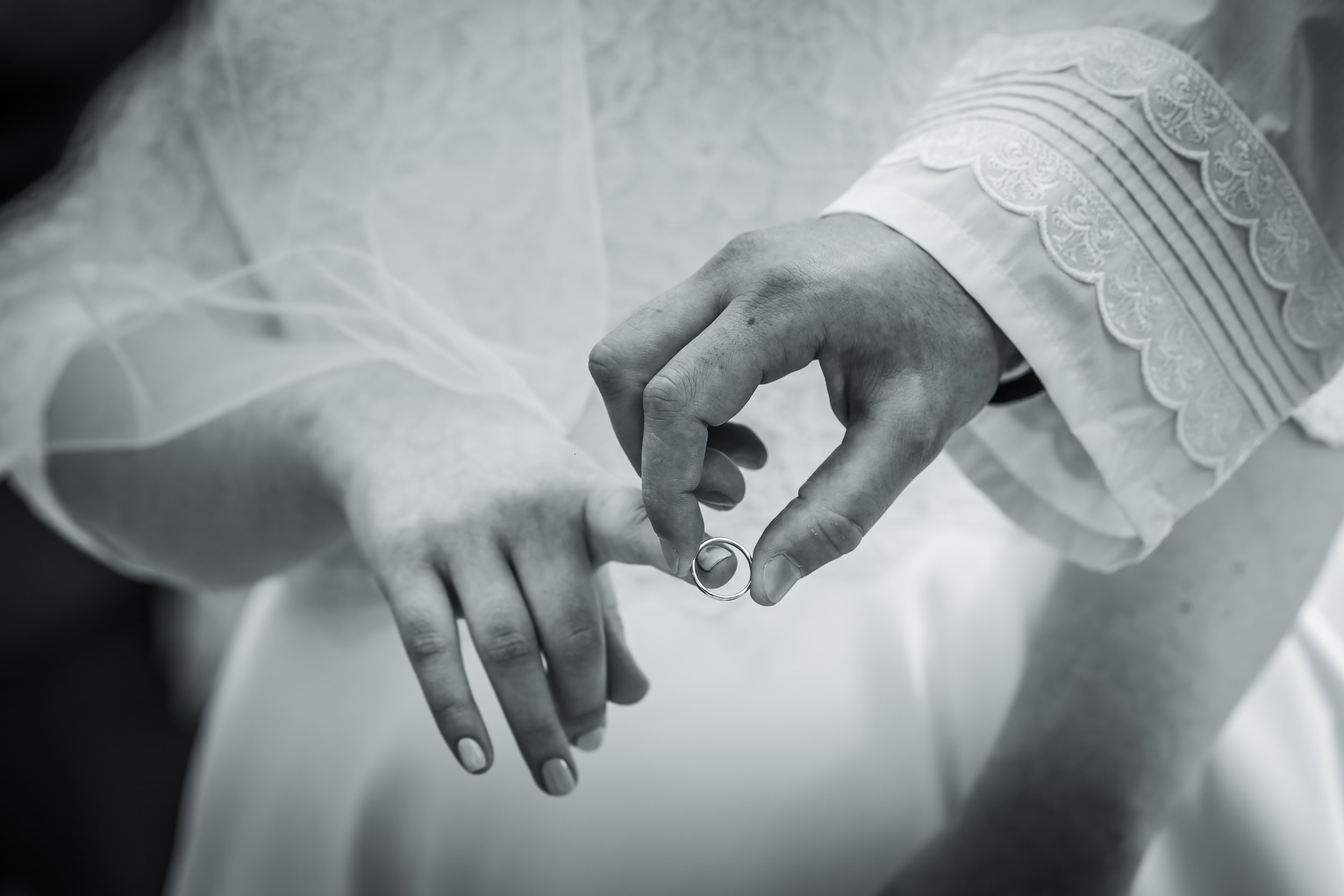chosson groom puts ring on kallah bride's finger under chuppah at charedi jewish wedding ceremony