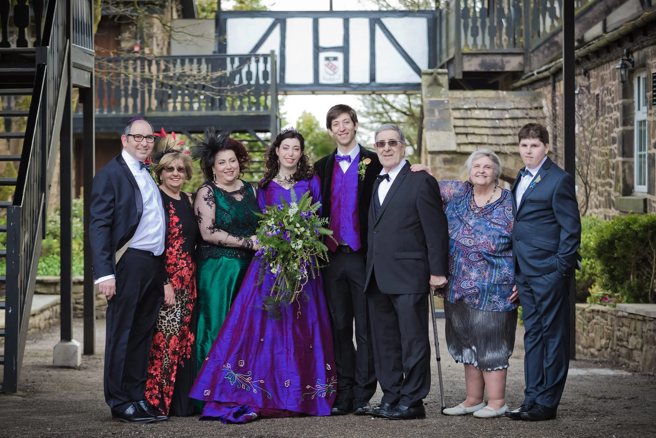 family portraits in courtyard at last drop village wedding venue in bolton
