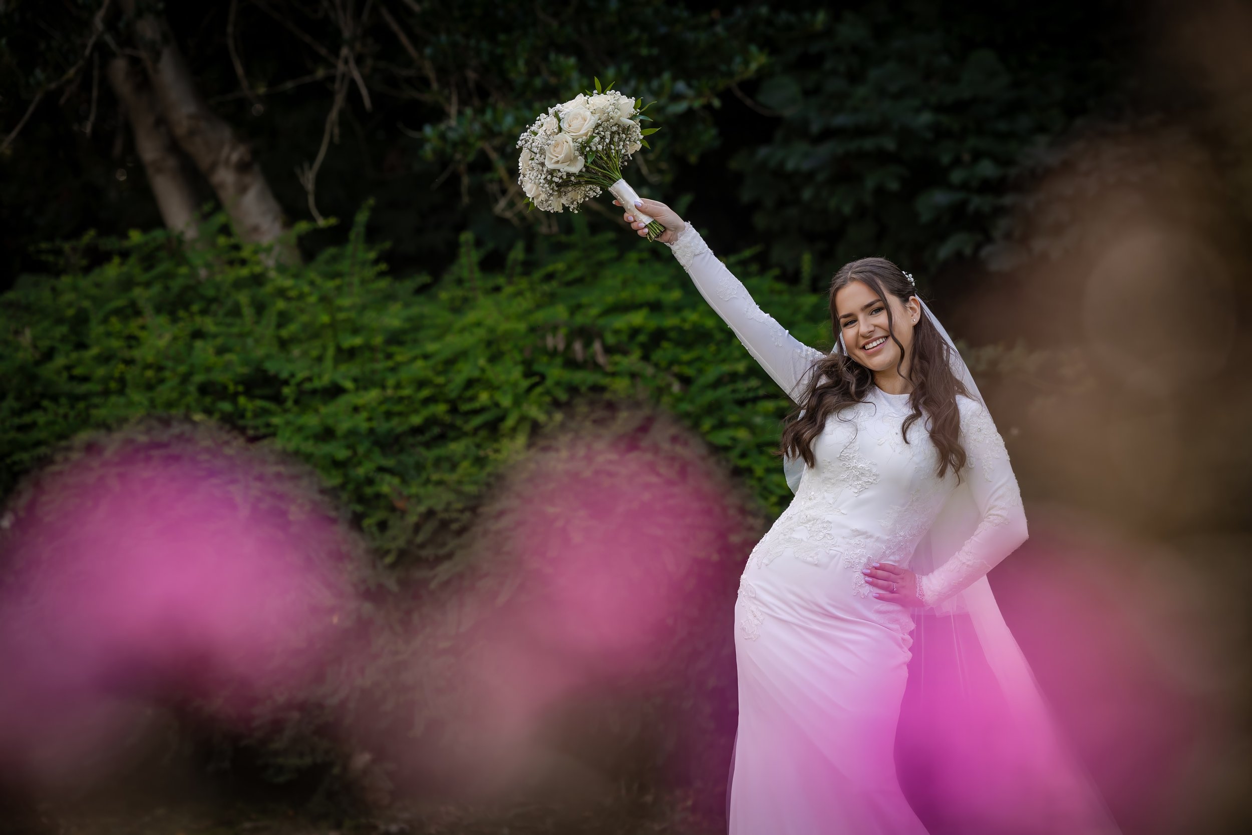 portrait of kallah bride in park with flowers