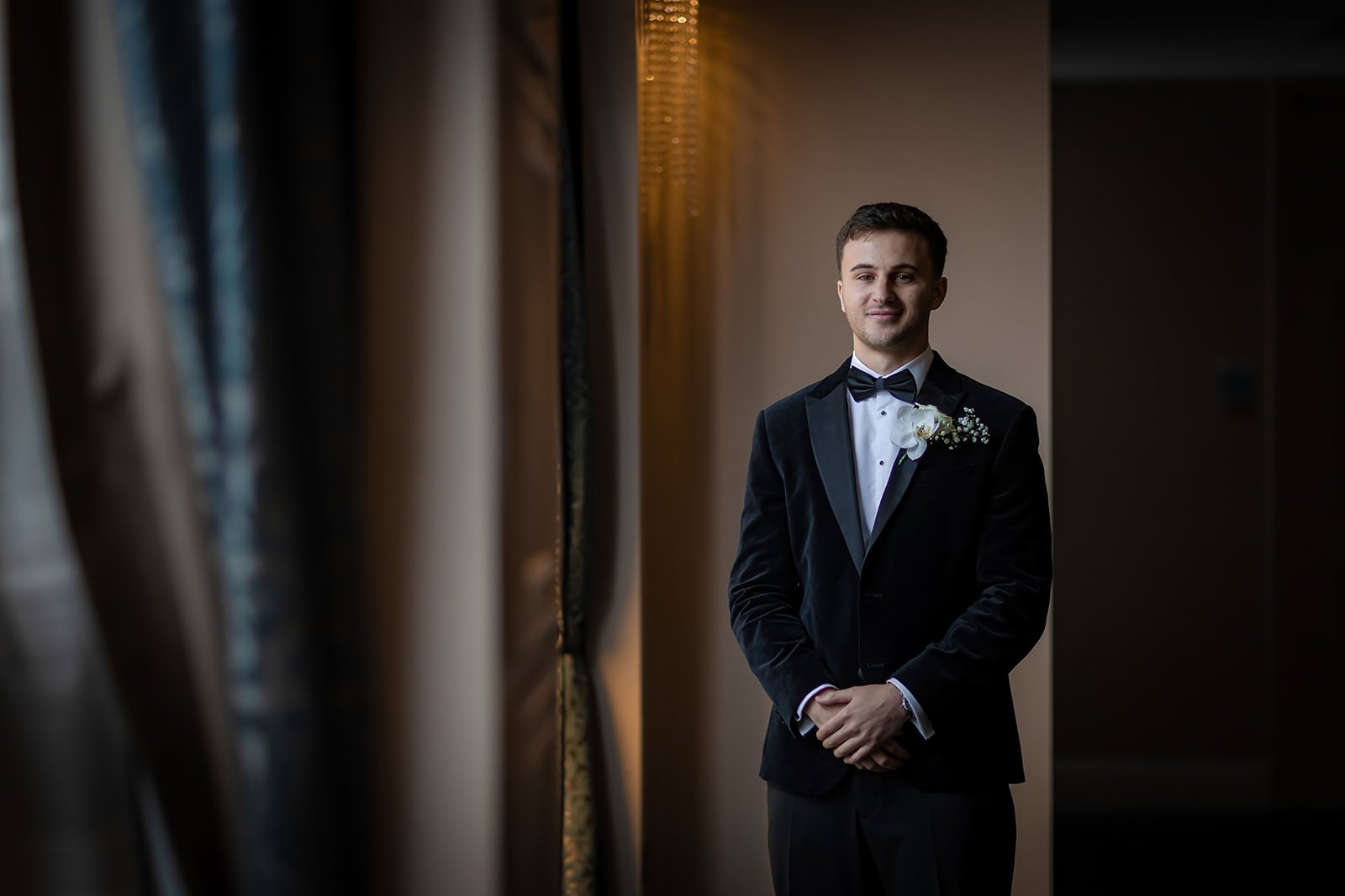 groom portrait by window during prep at mercure manchester piccadilly