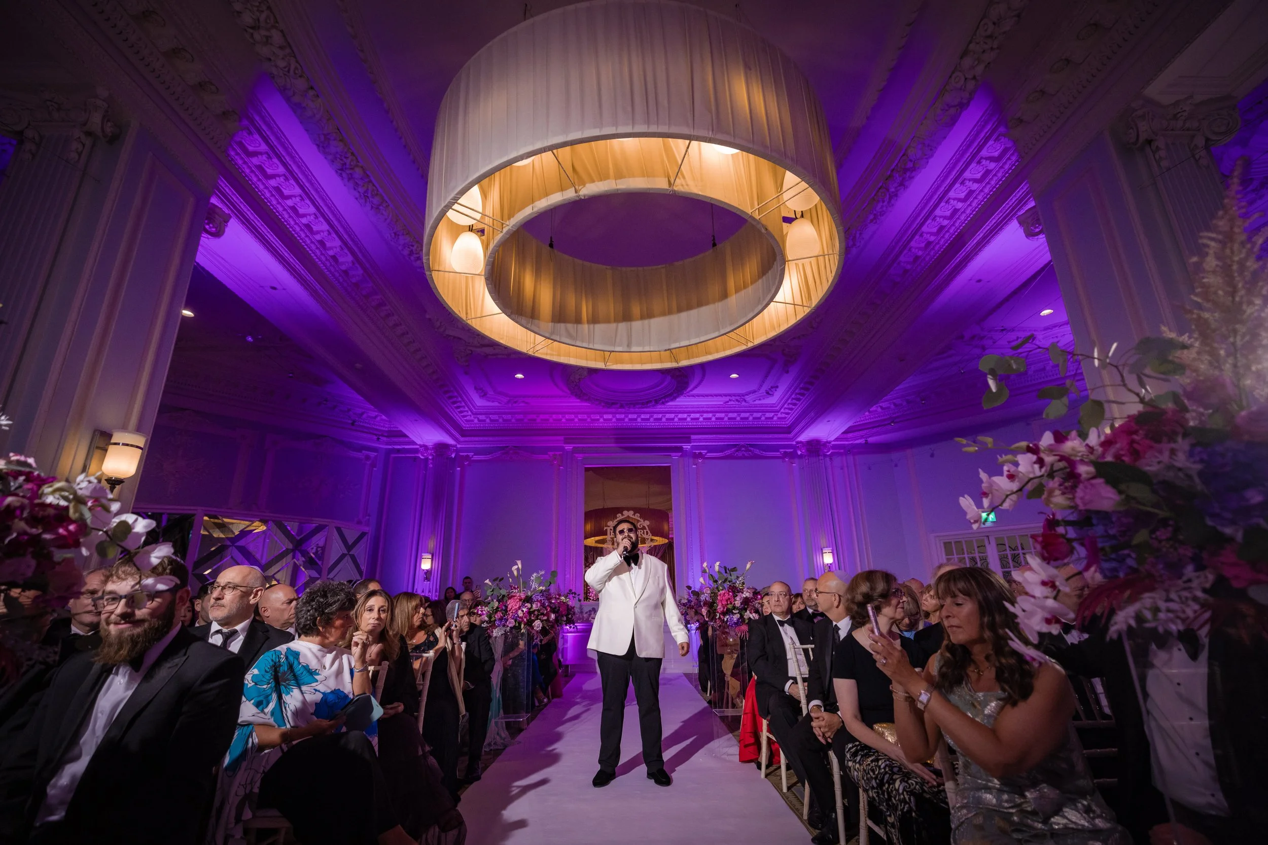wedding singer performing in the aisle in trafford suite at midland hotel in aisle