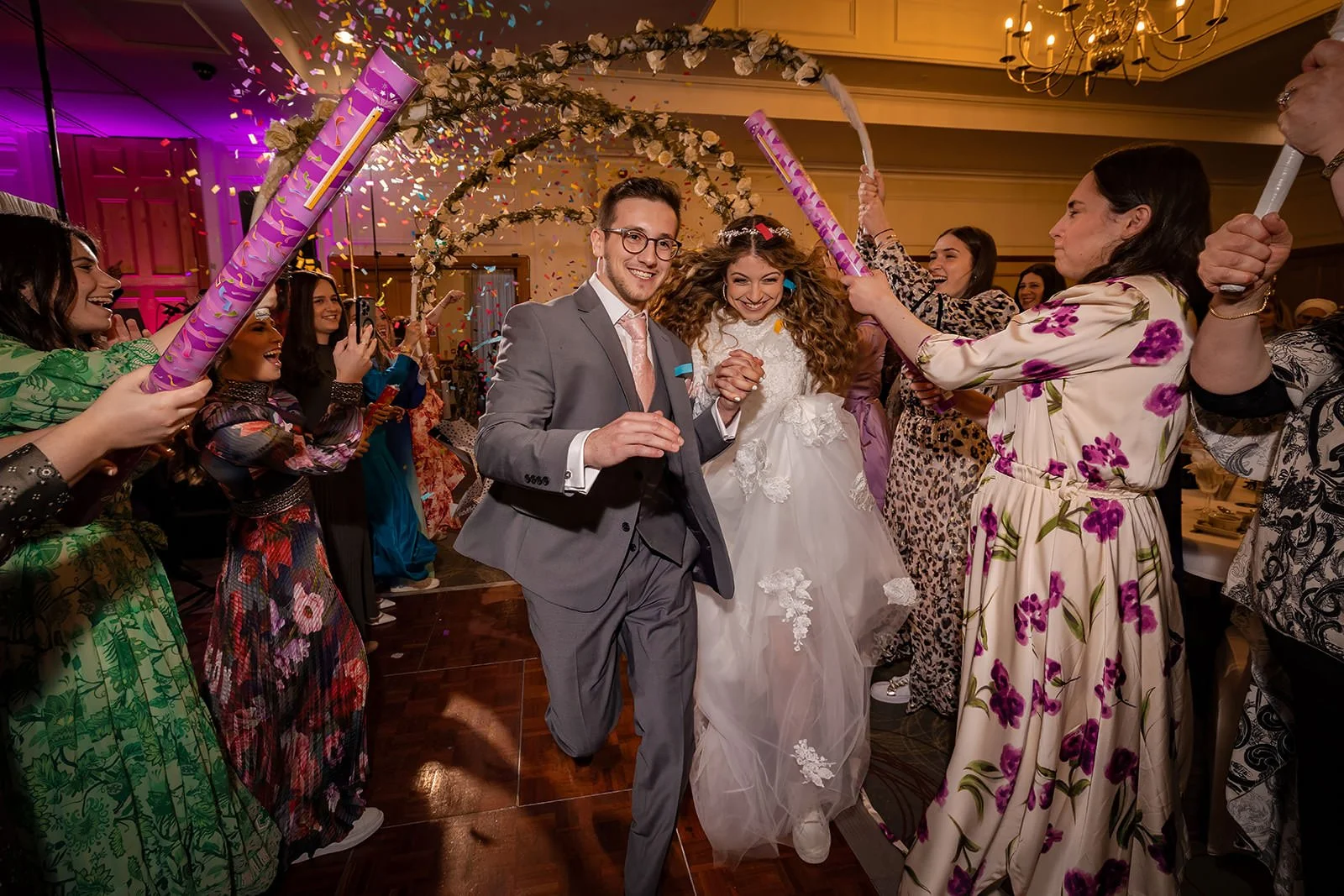 bride and groom make entrance onto dance floor during wedding party reception at last drop village in bolton