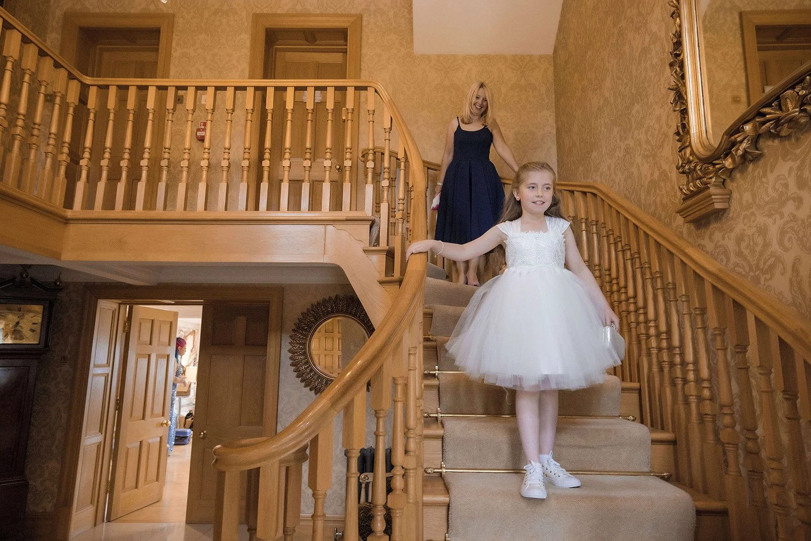 Merrydale Manor wedding flower girls descending staircase – documentary wedding photographer Manchester