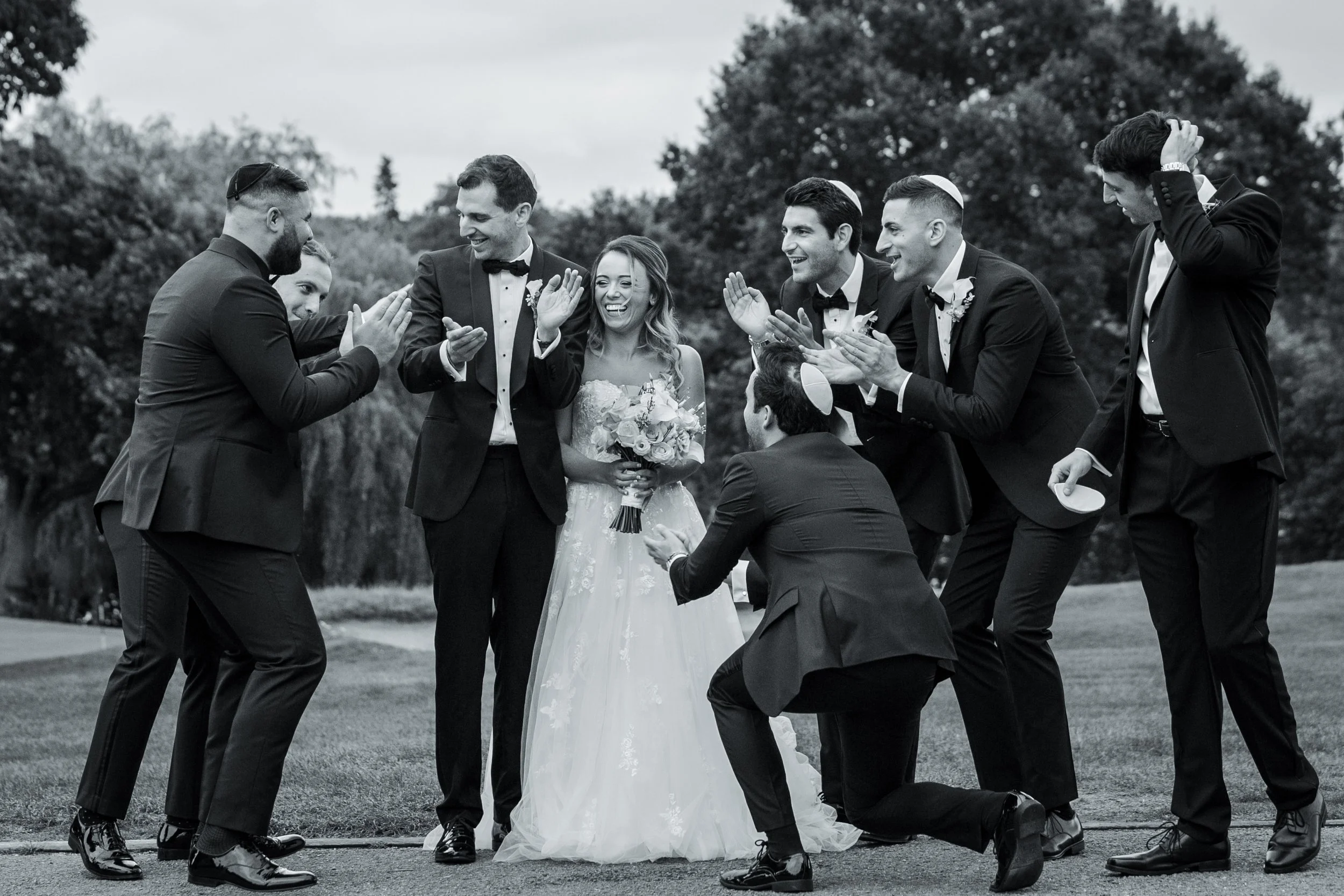 Jewish bride and groom newlywed couple portraits with friends groomsmen and photographed by a Manchester wedding photographer 
