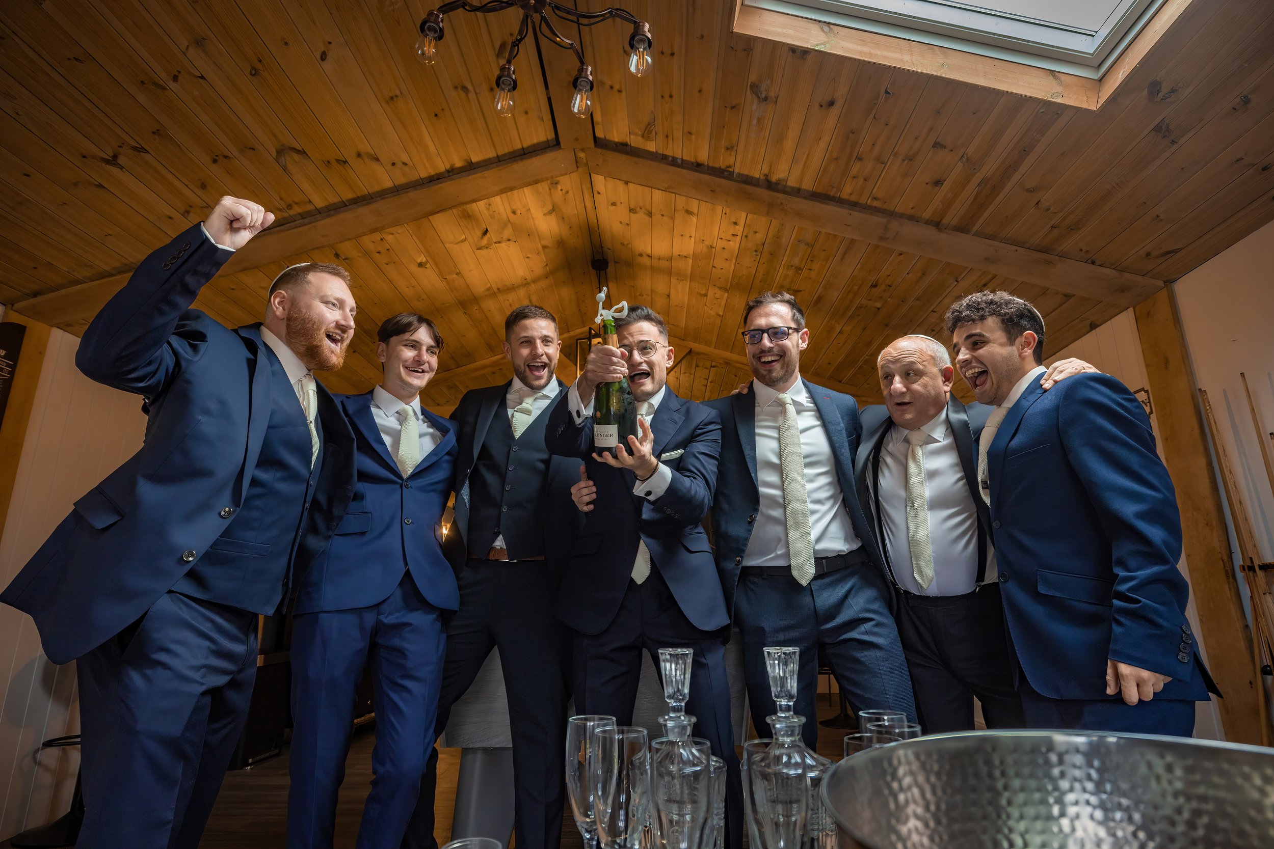 Merrydale Manor wedding groomsmen celebrating with champagne at reception – wedding photographer North West England