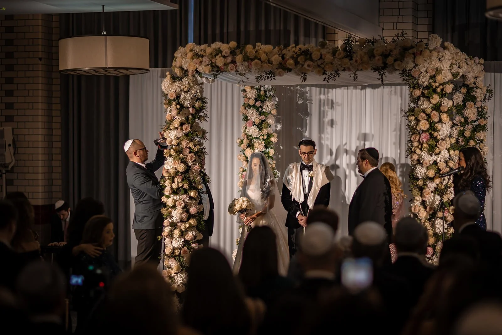 bride and groom exchange vows during wedding ceremony in ballroom at kimpton clocktower manchester