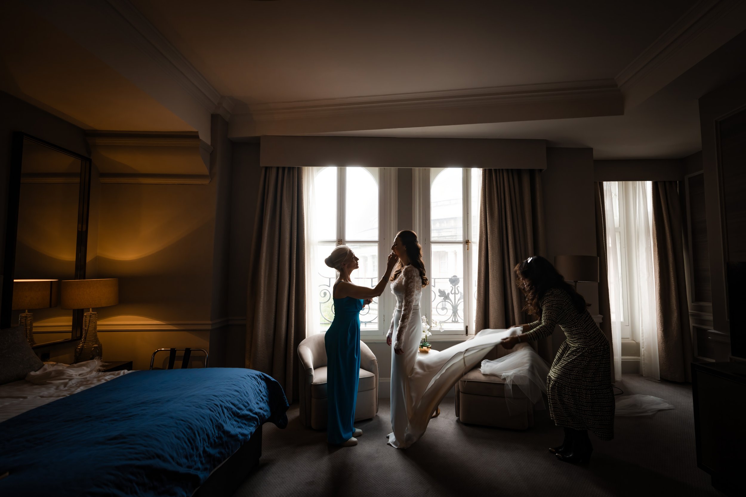 bride has final touches in dress after bridal prep at Midland Hotel in Manchester