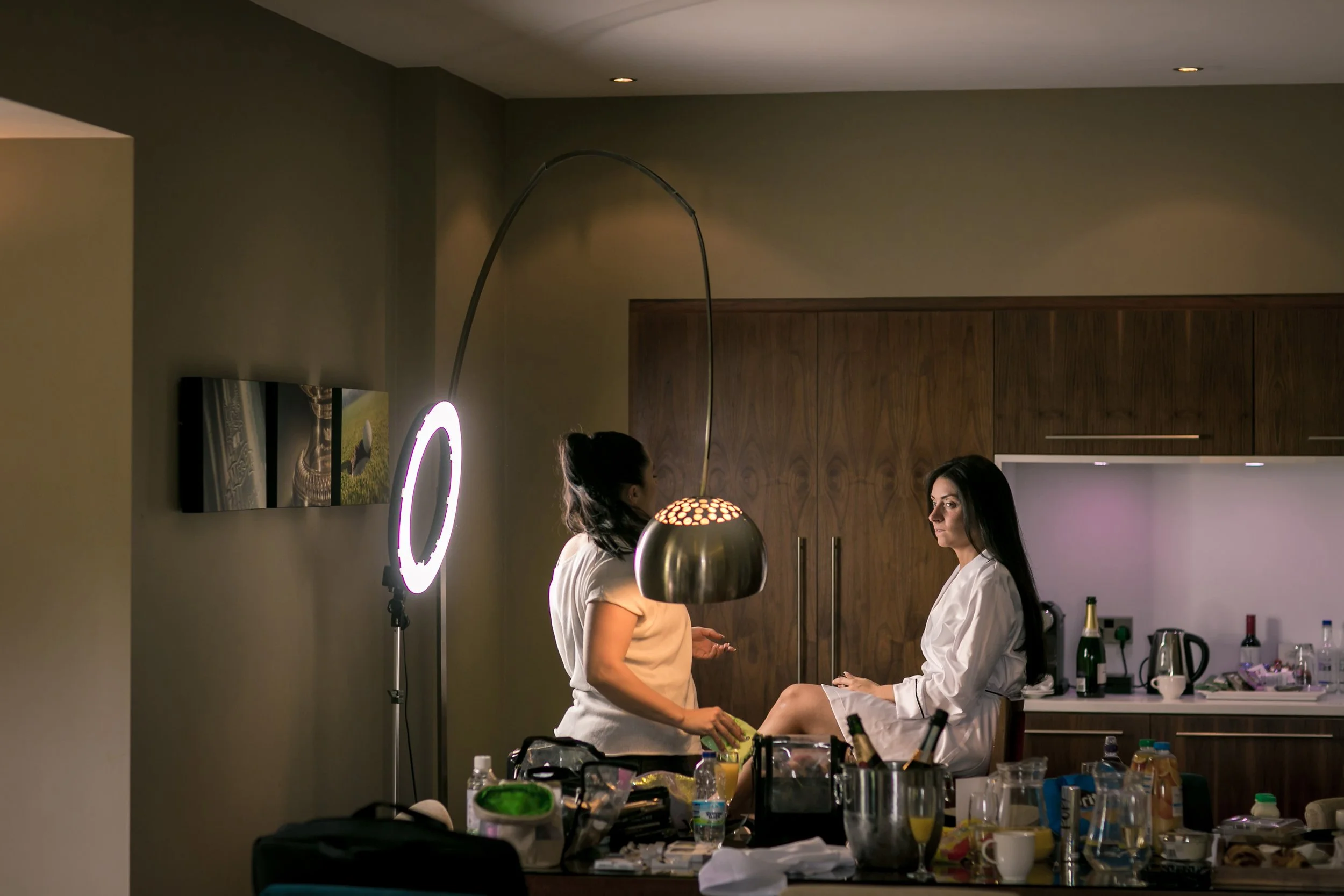 Bride in robe at makeup station with ring light, The Mere hotel room
